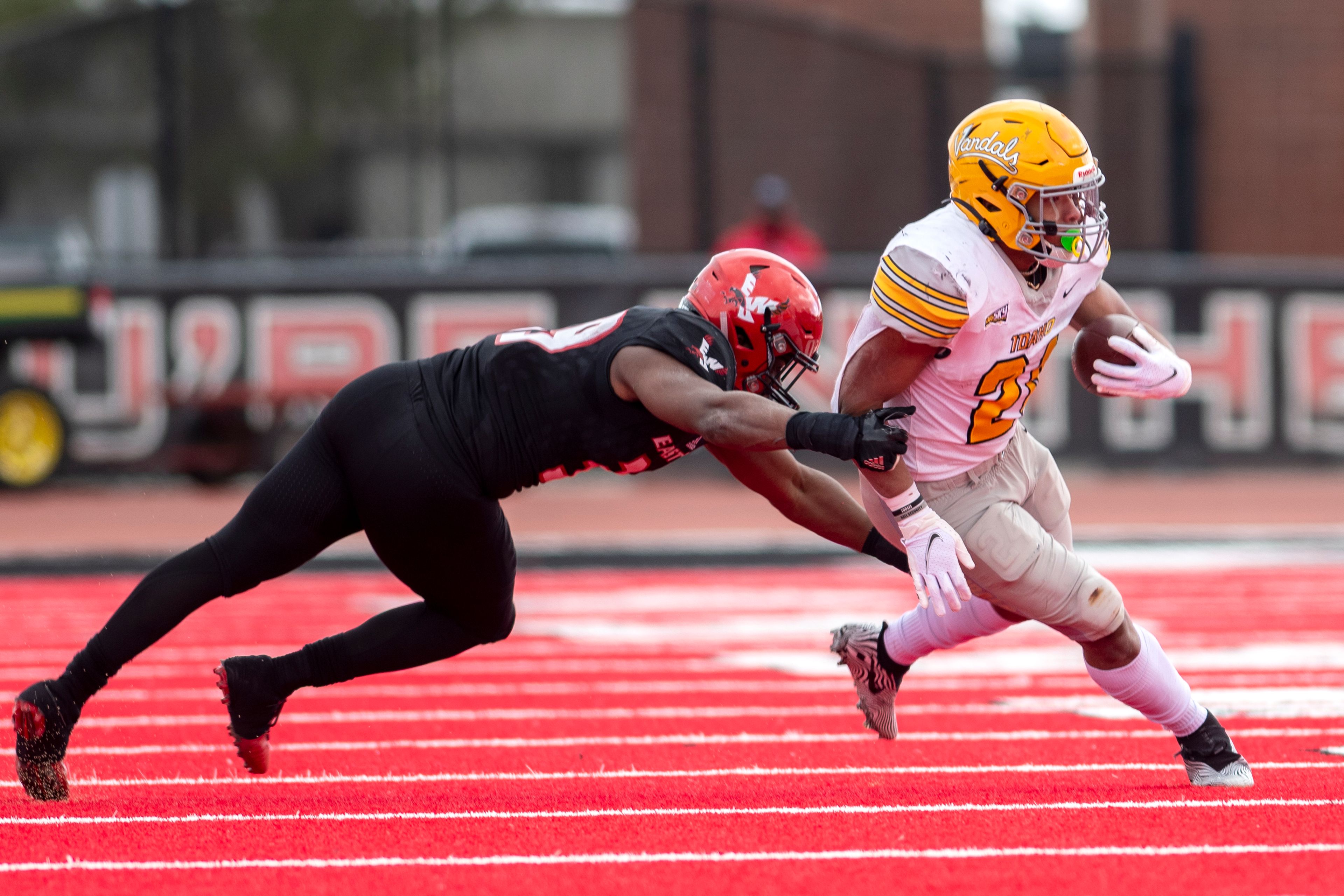 Idaho running back Roshaun Johnson (24) breaks a tackle from Eastern Washington linebacker Justin Patterson (39) during the fourth quarter of a Big Sky Conference matchup at Roos Field on Saturday afternoon. Eastern Washington defeated Idaho 38-31.