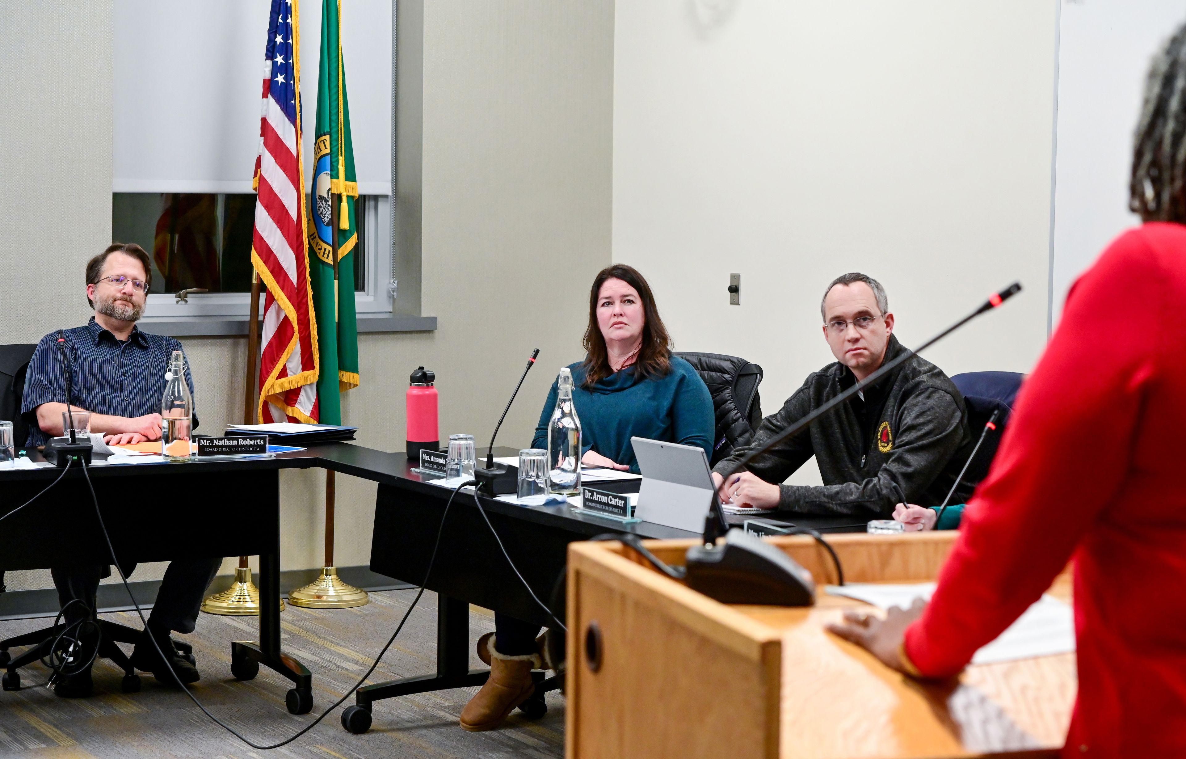 Members of the Pullman Public Schools Board of Directors listen as Donna Moore, right, a paraeducator at Sunnyside Elementary School, speaks during public comment at a meeting on Wednesday.