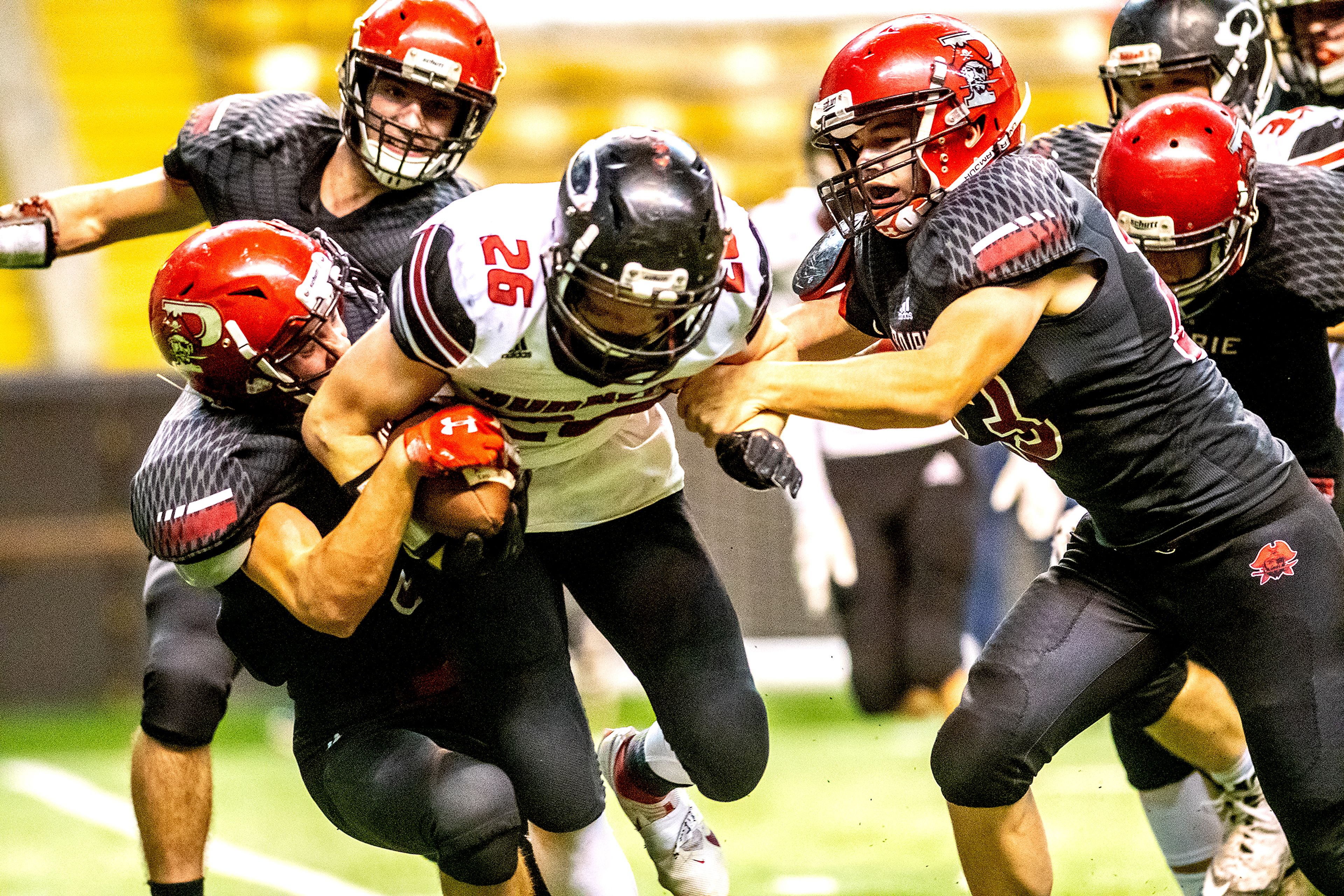 Oakley’s Isaac Mitton is brought down by Prairie’s Dalton Ross (left) and Chase Kaschmitter. The Prairie Pirates lost to the Oakley Hornets 42-40 in the Class 1A Division O state semifinal football game at the Kibbie Dome in Moscow on Friday.