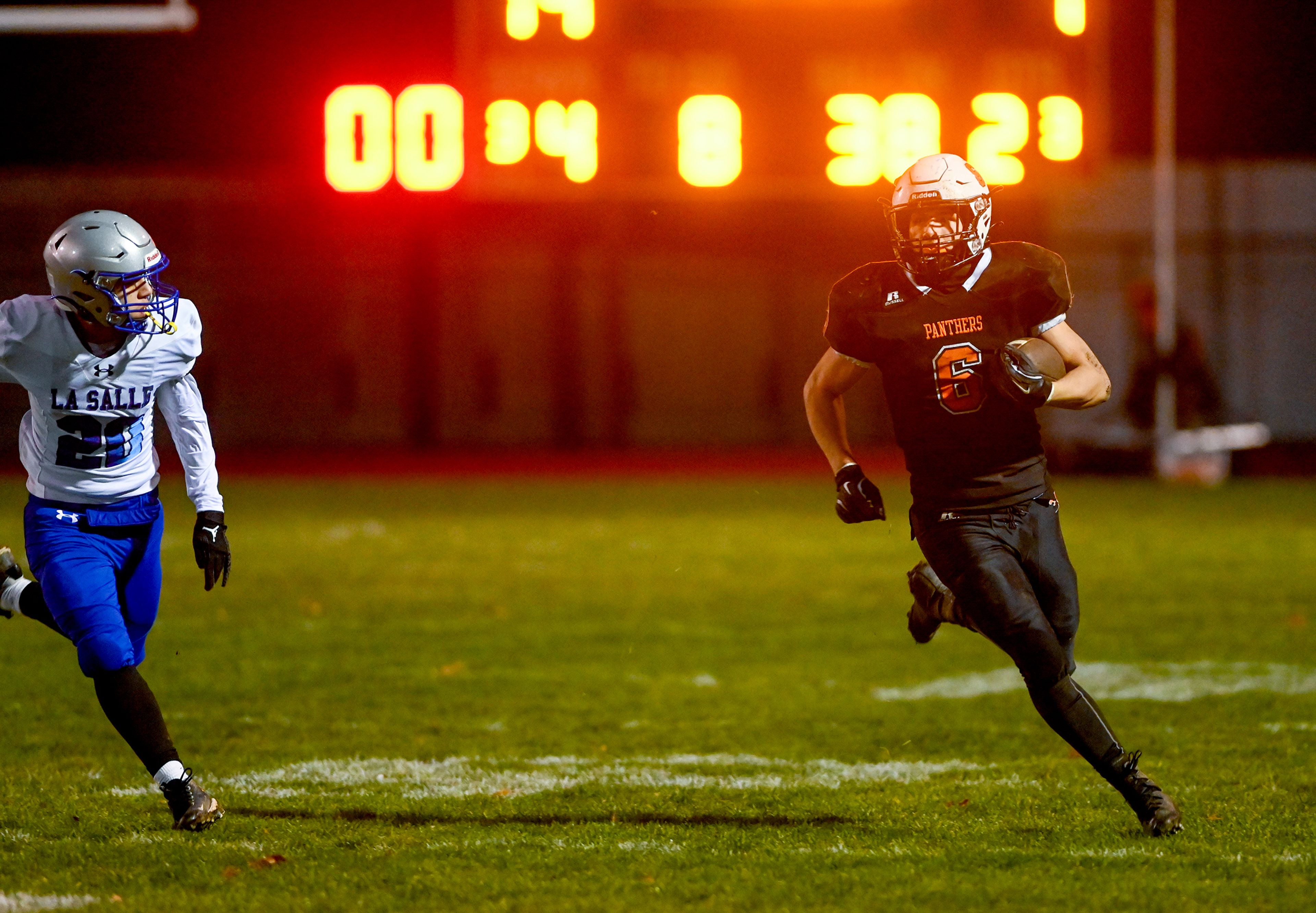 Asotin’s Peter Eggleston carries the ball down the field for a first down Saturday during a Washington 2B state tournament game against La Salle in Clarkston.