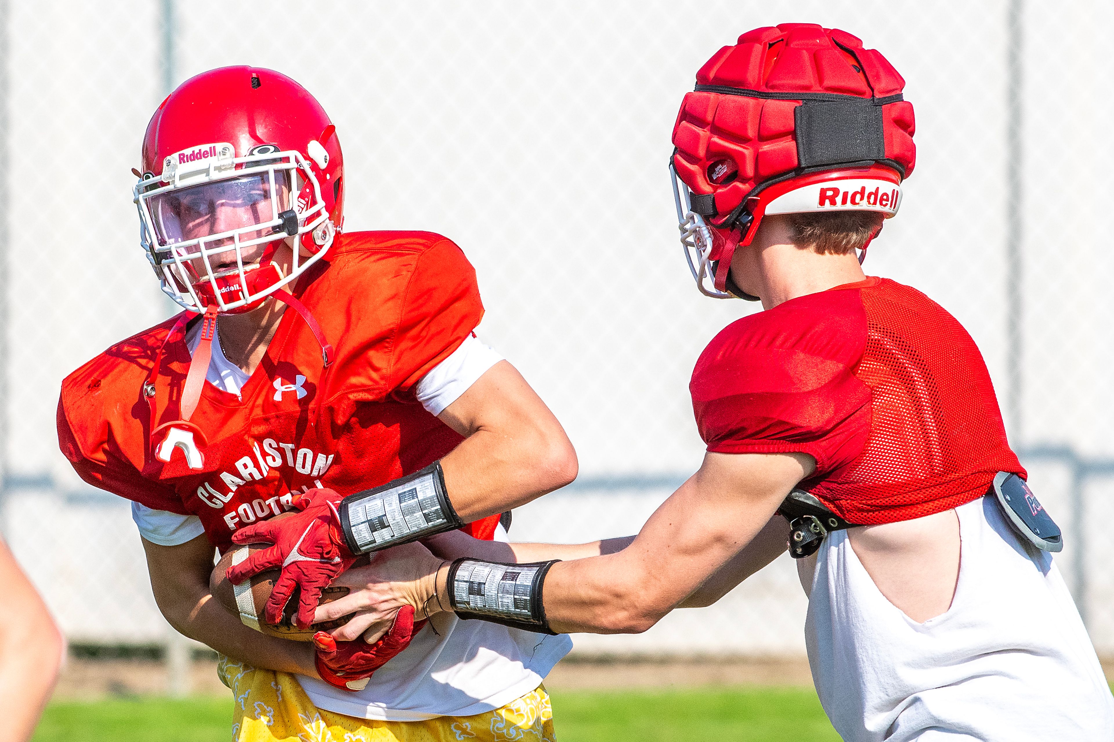 Clarkston runs plays at football practice Tuesday in Clarkston.