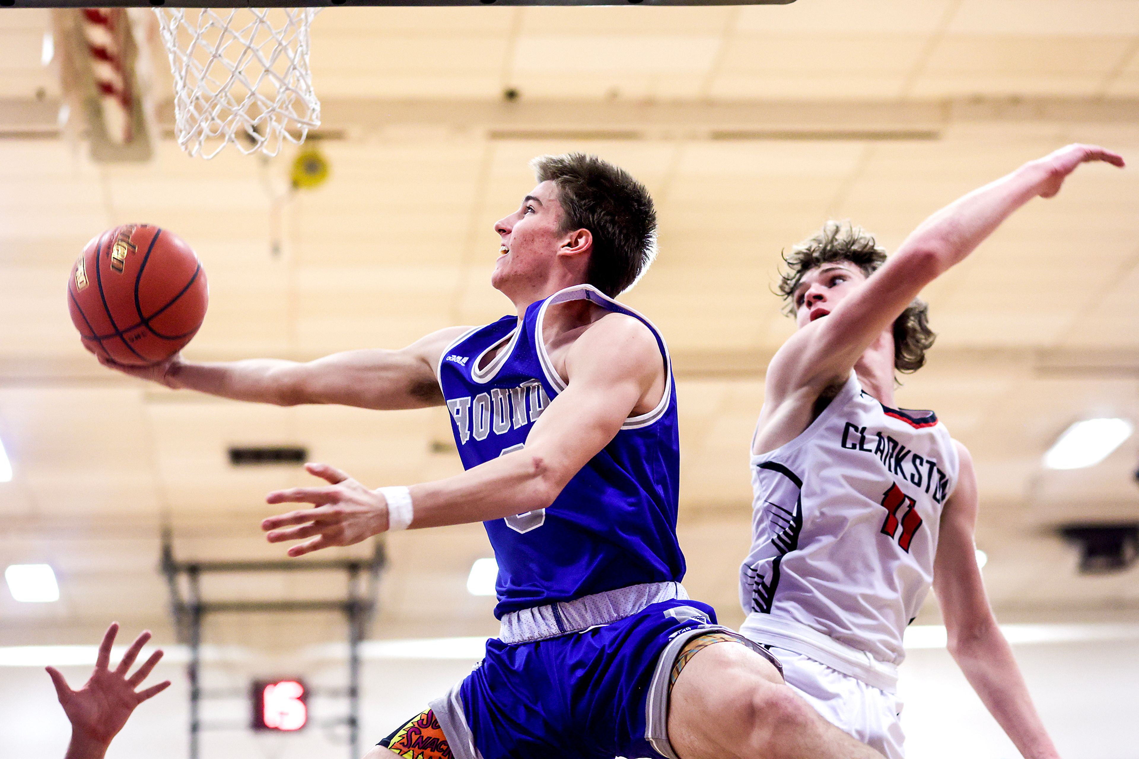 Pullman shooting guard Tanner Barbour, left, gets past Clarkston forward Dustin Beck to take a shot during Tuesday's Class 2A Greater Spokane League boys basketball game.