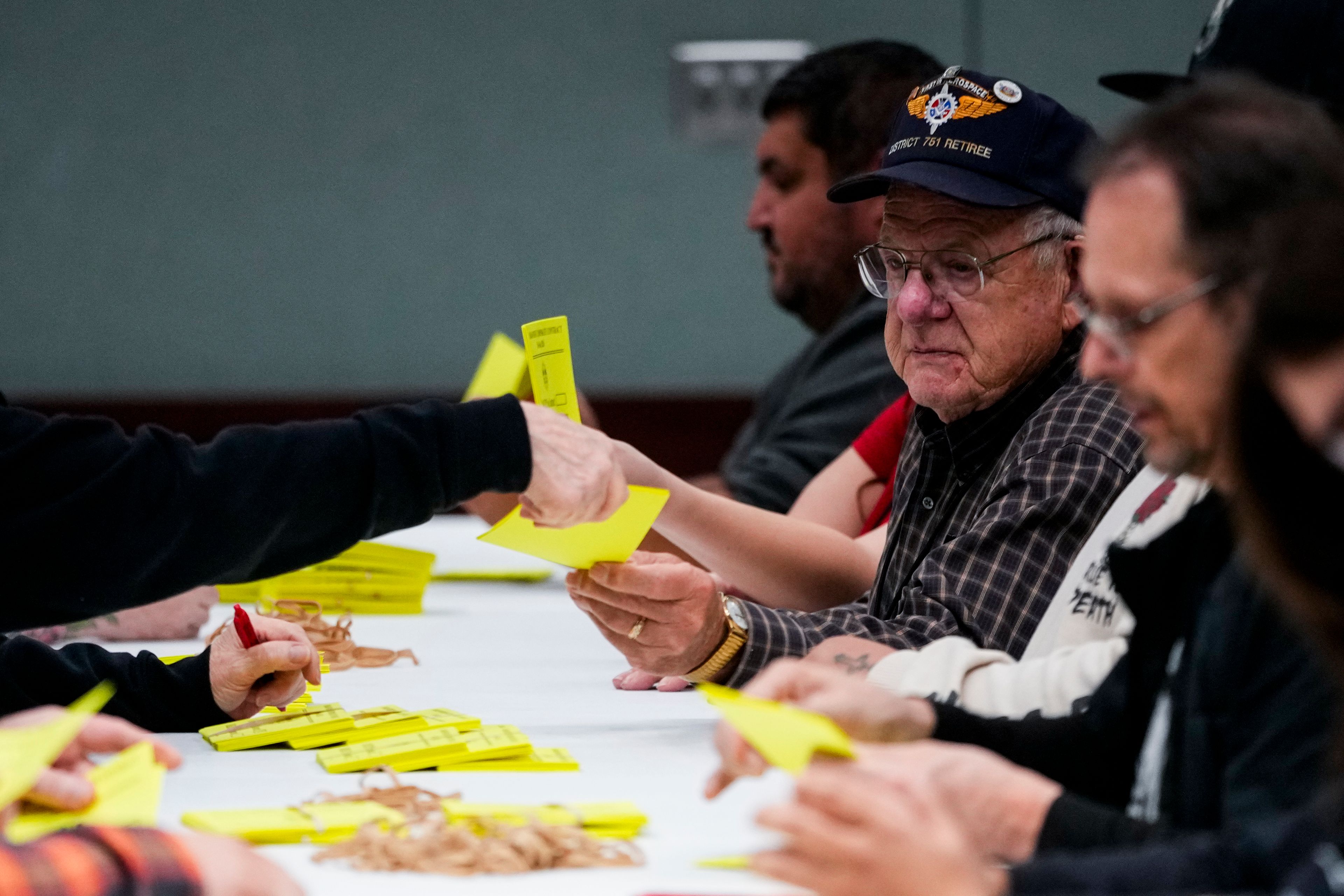 Volunteers tally votes on a new contract offer from Boeing, Wednesday, Oct. 23, 2024, at Seattle Union Hall in Seattle. (AP Photo/Lindsey Wasson)