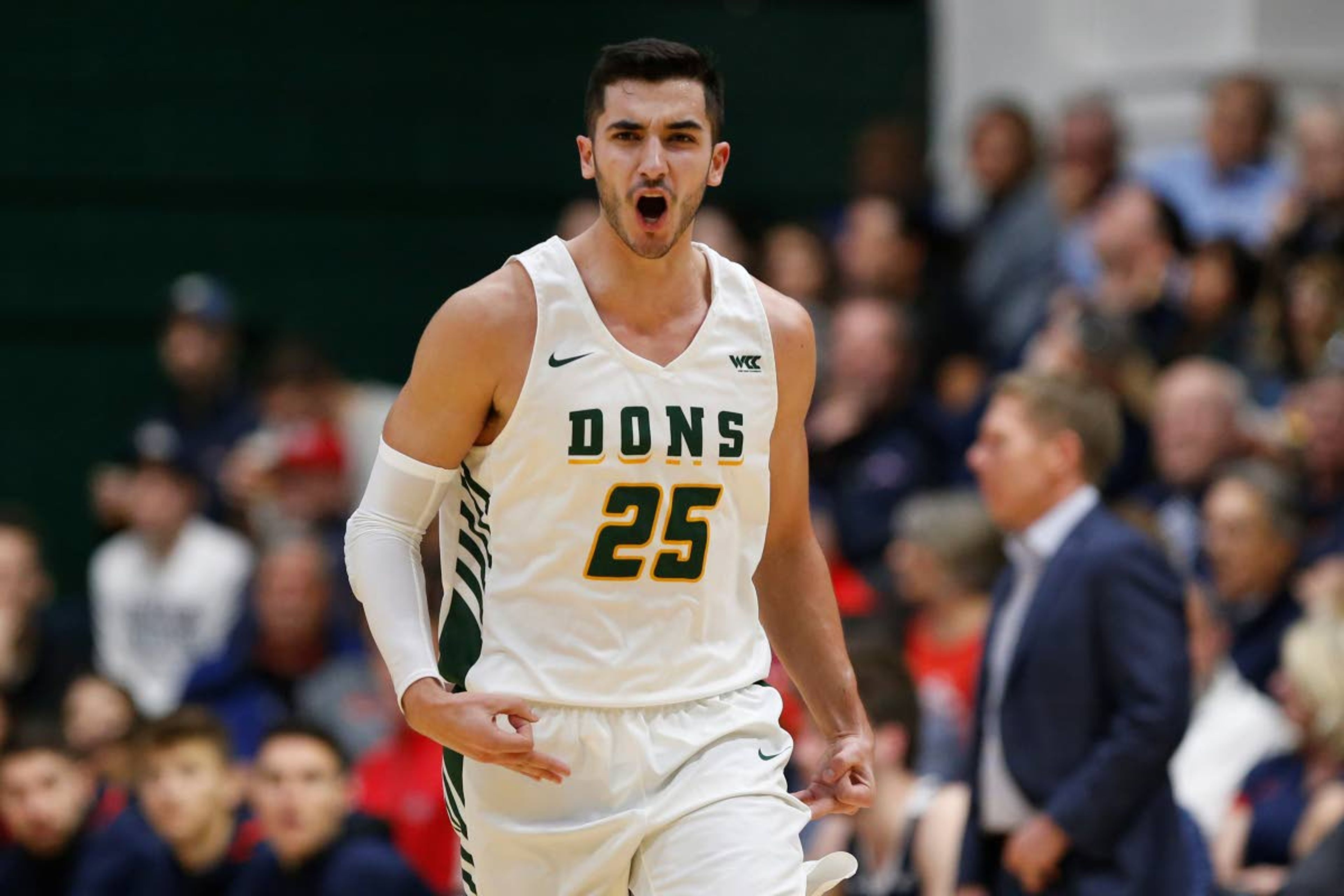 San Francisco guard Jordan Ratinho (25) celebrates after a three-point basket against Gonzaga during the first half of an NCAA college basketball game in San Francisco, Saturday, Feb. 1, 2020. (AP Photo/Jed Jacobsohn)