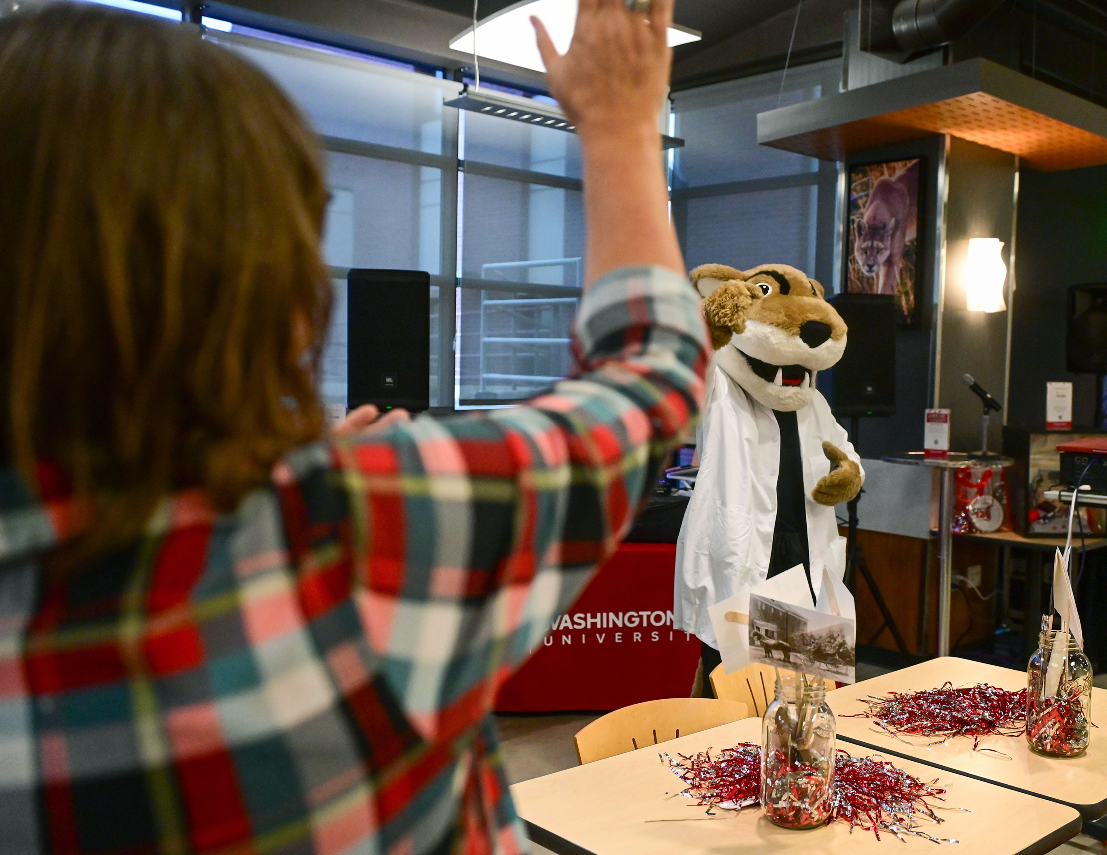 Washington State University Mascot Butch T. Cougar leads students, faculty, alumni and community members in a fight song Friday at a celebration event for the 125th anniversary of the WSU College of Veterinary Medicine in Pullman.