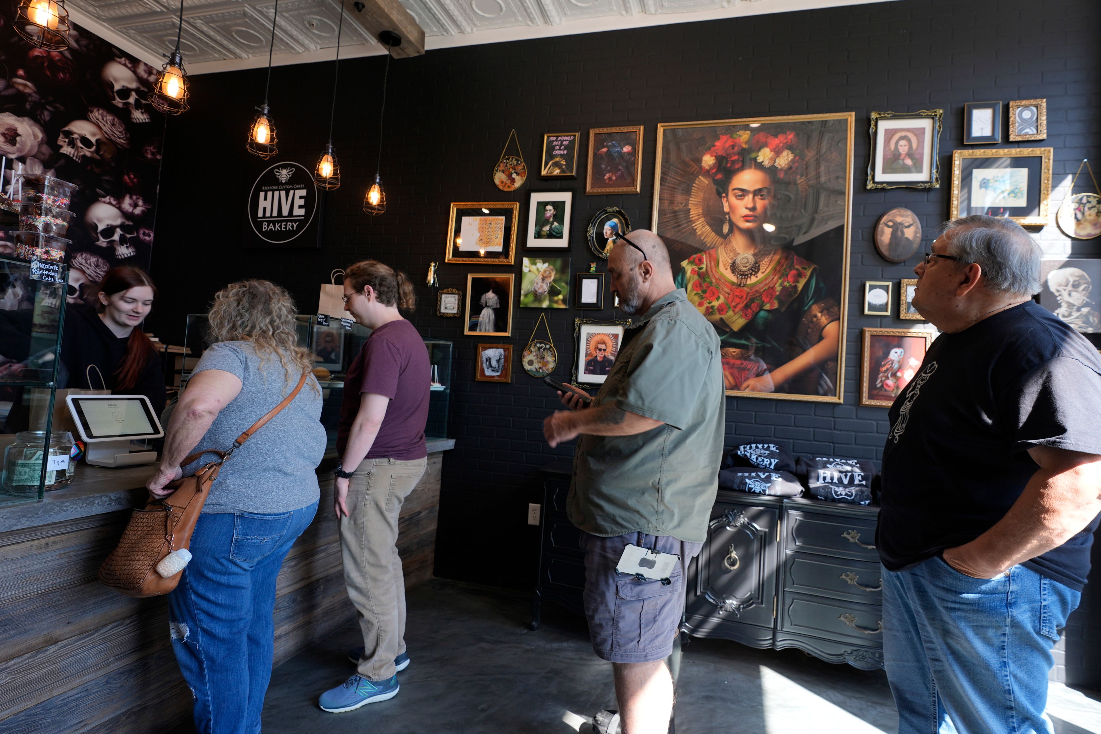 Customers line up at the Bee Bakery in Flower Mound, Texas, Friday, Oct. 4, 2024. (AP Photo/LM Otero)