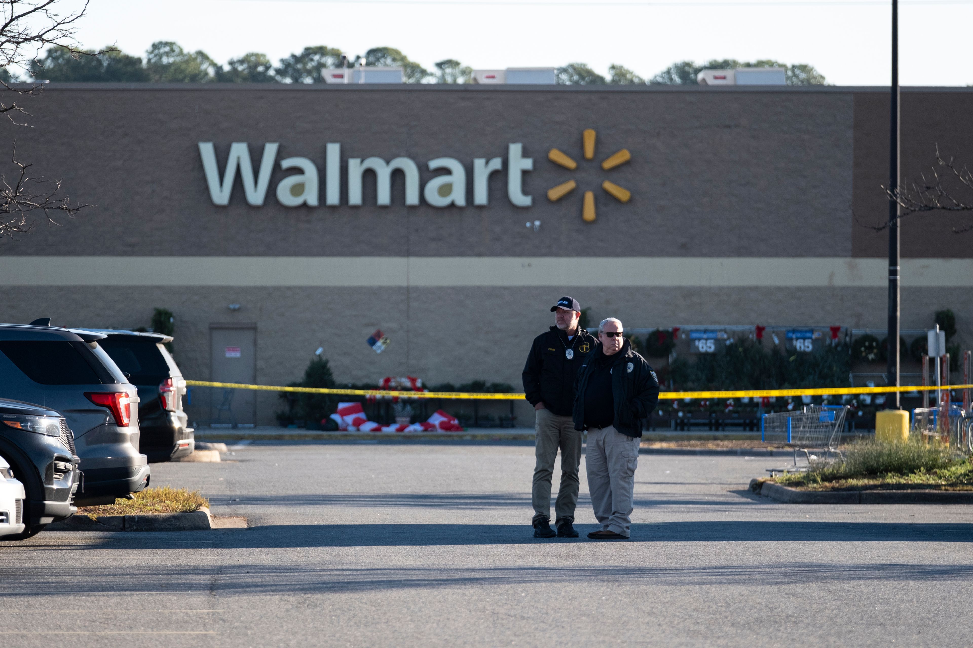 Police wait outside a Walmart in Chesapeake, Va. on Wednesday, Nov. 23, 2022 where the night before a mass shooting took place. (Billy Schuerman/The Virginian-Pilot via AP)