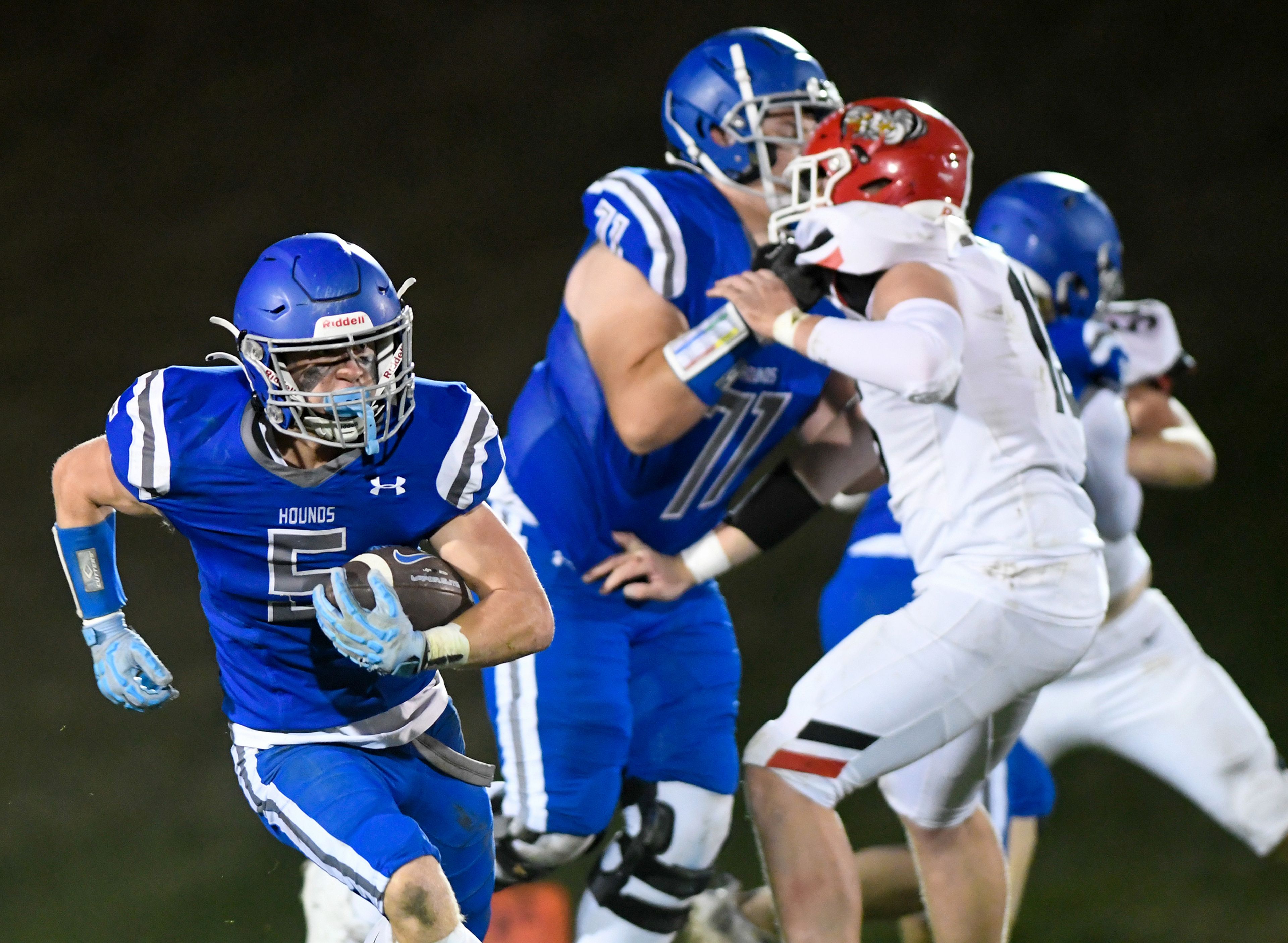 Pullmans Brady Coulter carries the ball as Pullman and Clarkston players collide Friday in Pullman.,