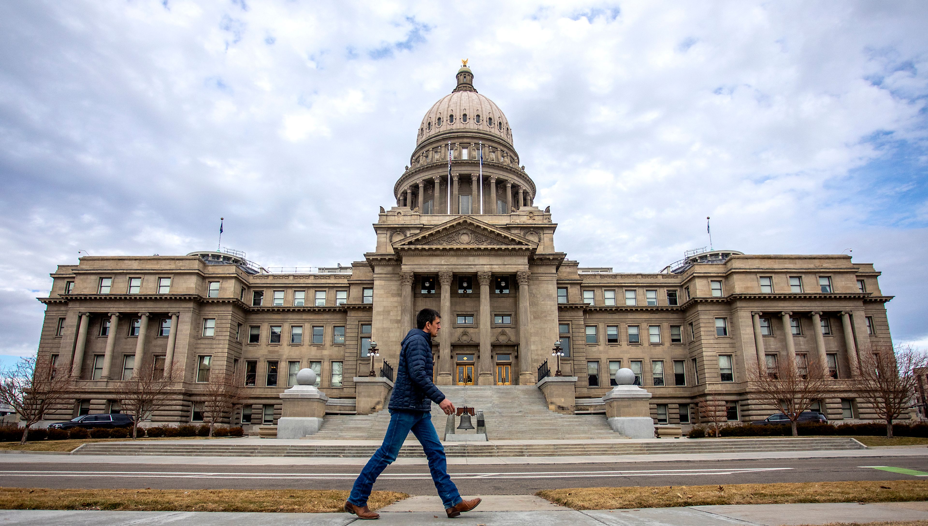 FILE — A man walks past the Idaho State Capitol March 2022.