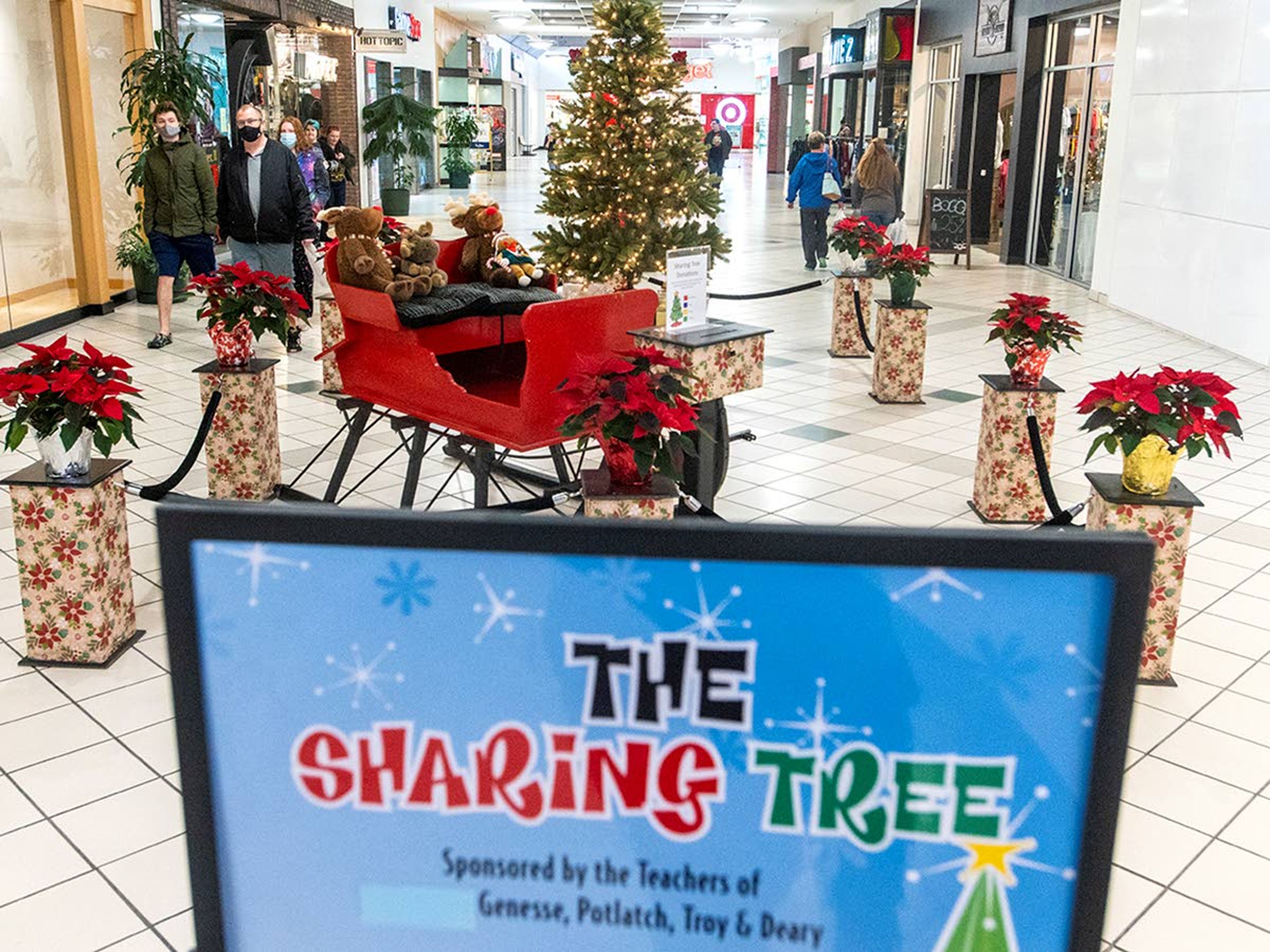 Shoppers walk by the Sharing Tree inside the Palouse Mall on Thursday morning. Every year, since its start in 1986, the tree is adorned with tags that represent a Christmas present waiting to be purchased for a child in need in Latah County.