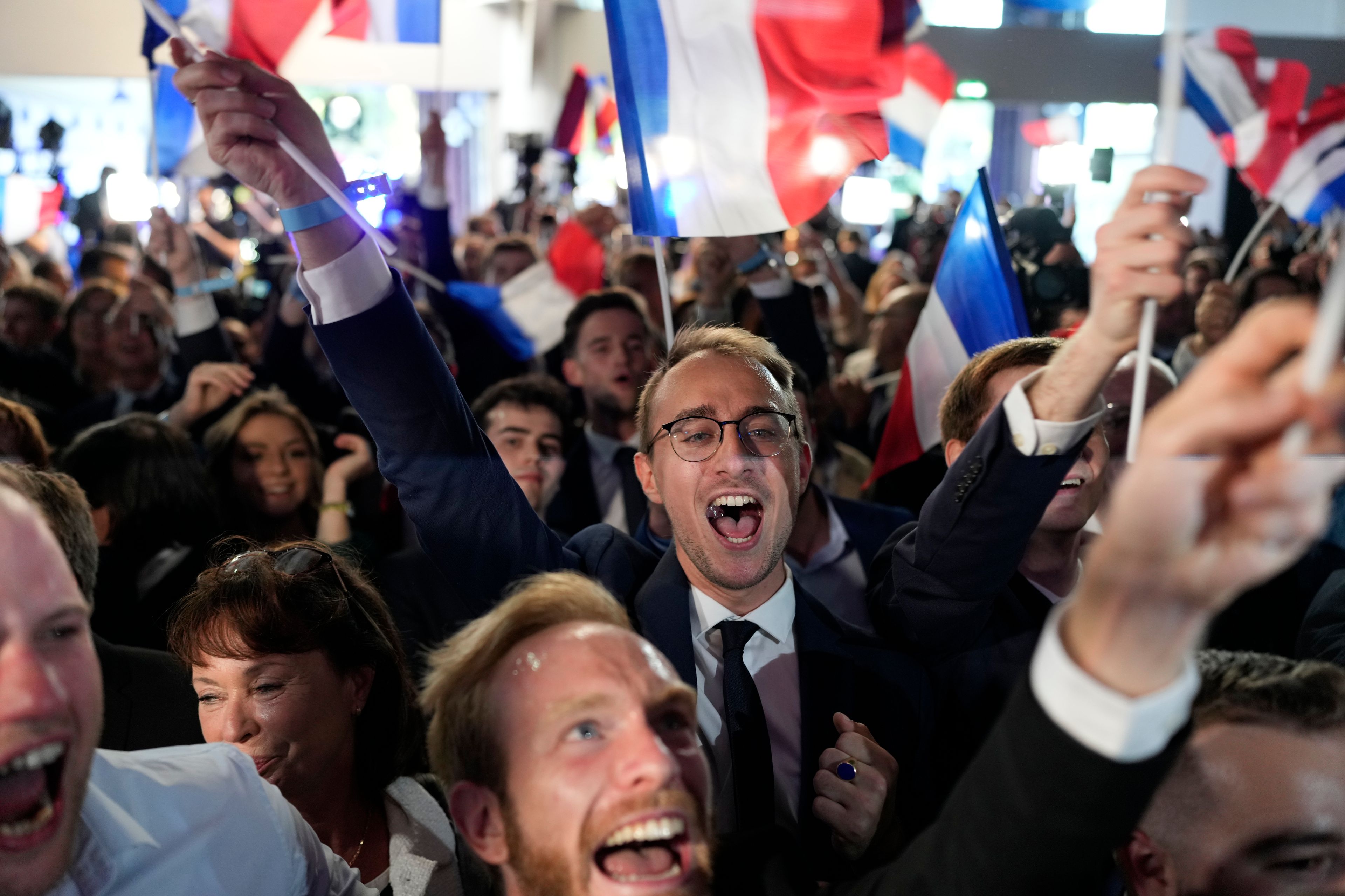 Supporters of French far-right National Rally react at the party election night headquarters, Sunday, June 9, 2024 in Paris. First projected results from France put far-right National Rally party well ahead in EU elections, according to French opinion poll institutes.