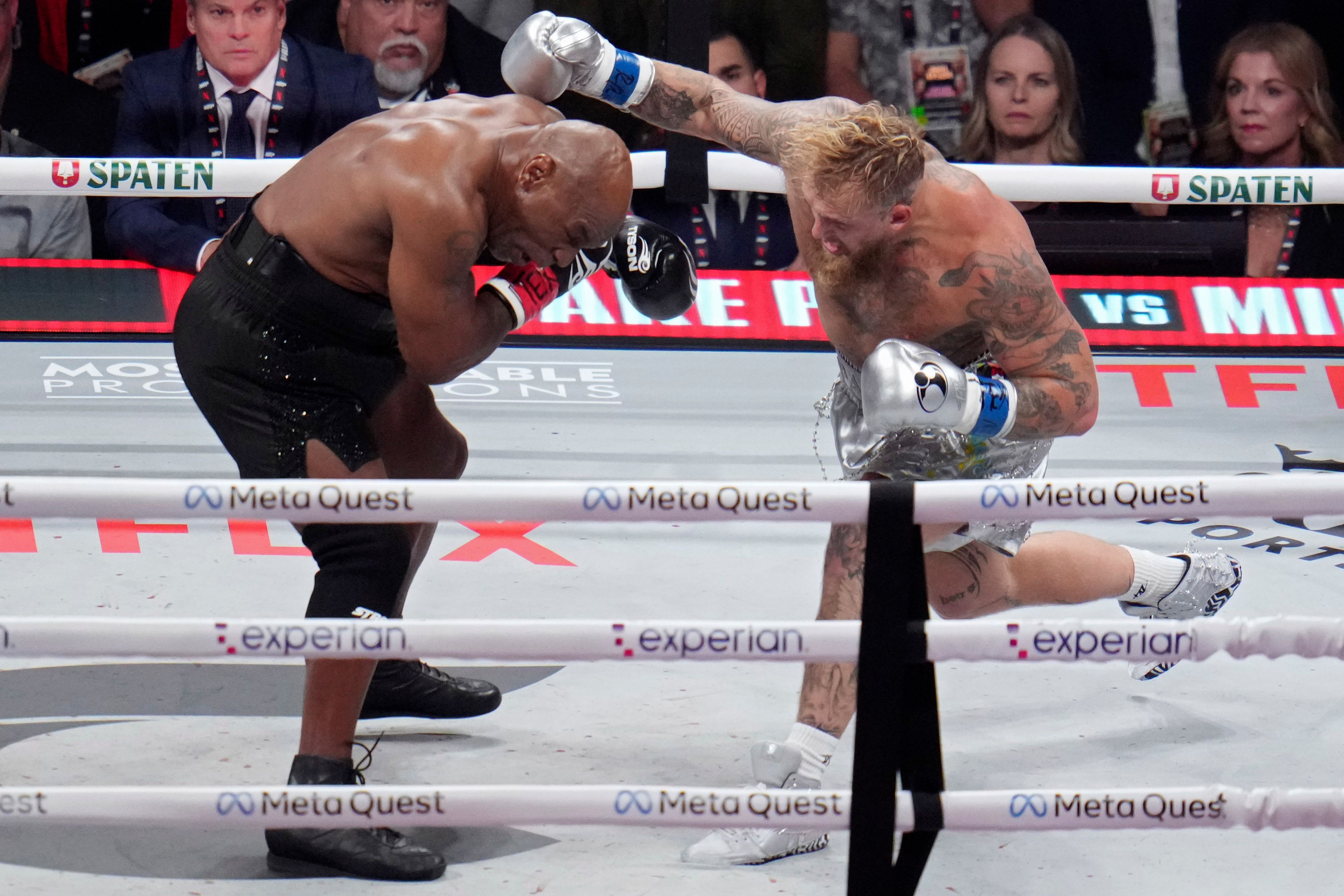 Jake Paul throws a punch at Mike Tyson during their heavyweight boxing match, Friday, Nov. 15, 2024, in Arlington, Texas. (AP Photo/Julio Cortez)