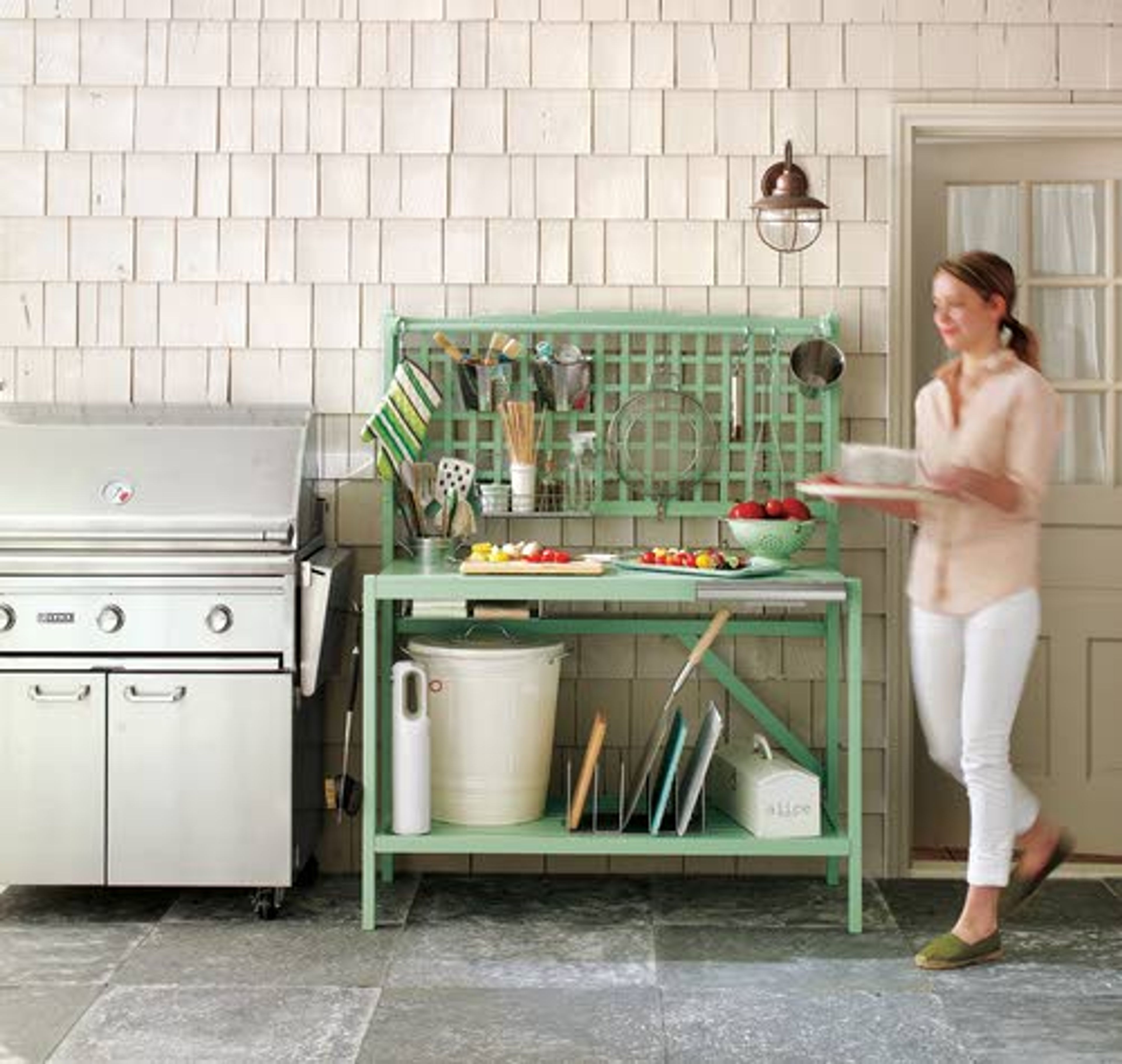 It’s made for the garden, but when accessorized appropriately, a collapsible wooden potting bench (below) becomes the ultimate grill station. Keep grilling essentials like whisks and potholders close by hanging them from a lattice (inset).