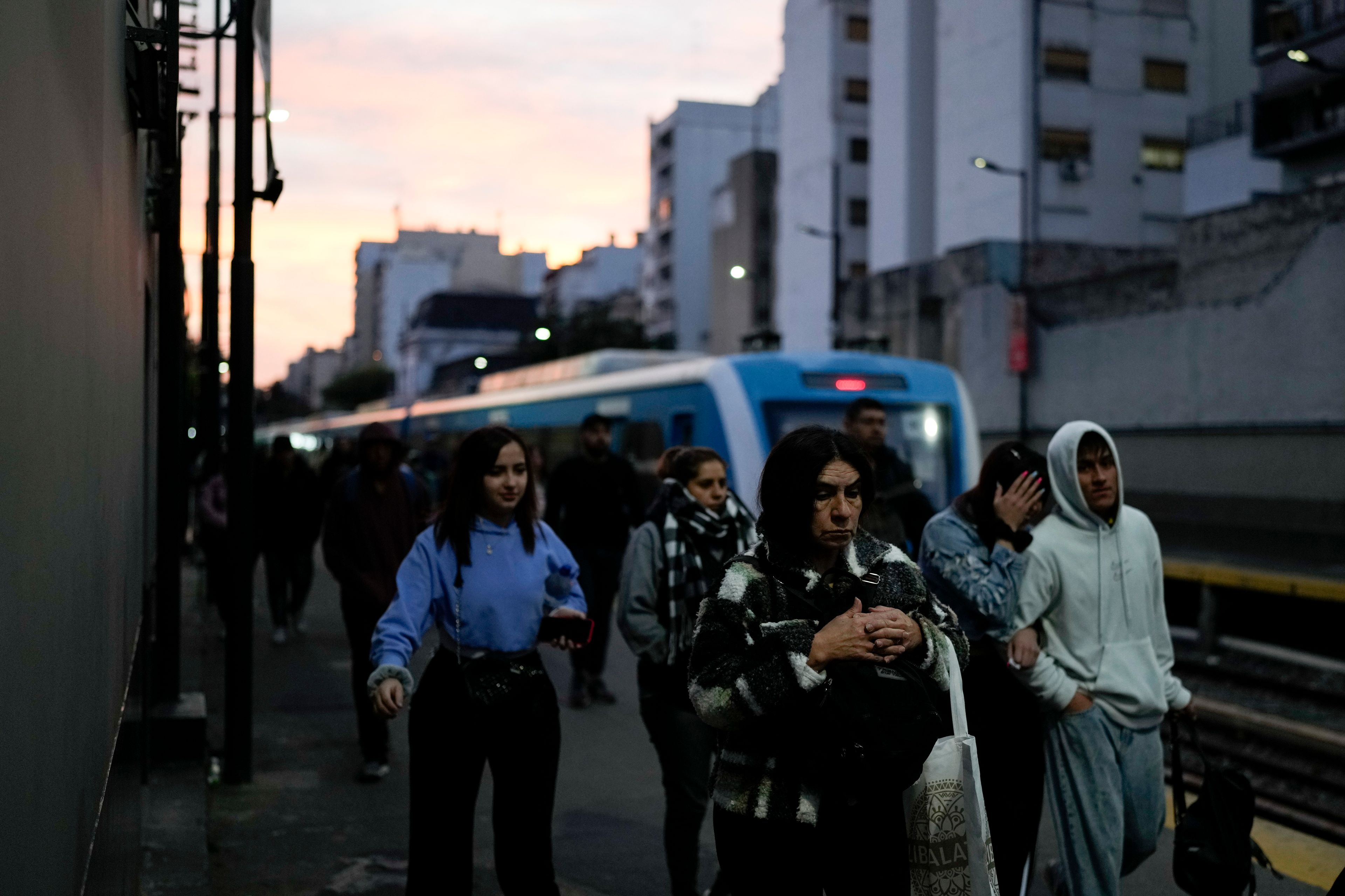 People get off the train, the cost of which is rising, in Buenos Aires, Argentina, Thursday, Sept. 19, 2024. (AP Photo/Natacha Pisarenko)