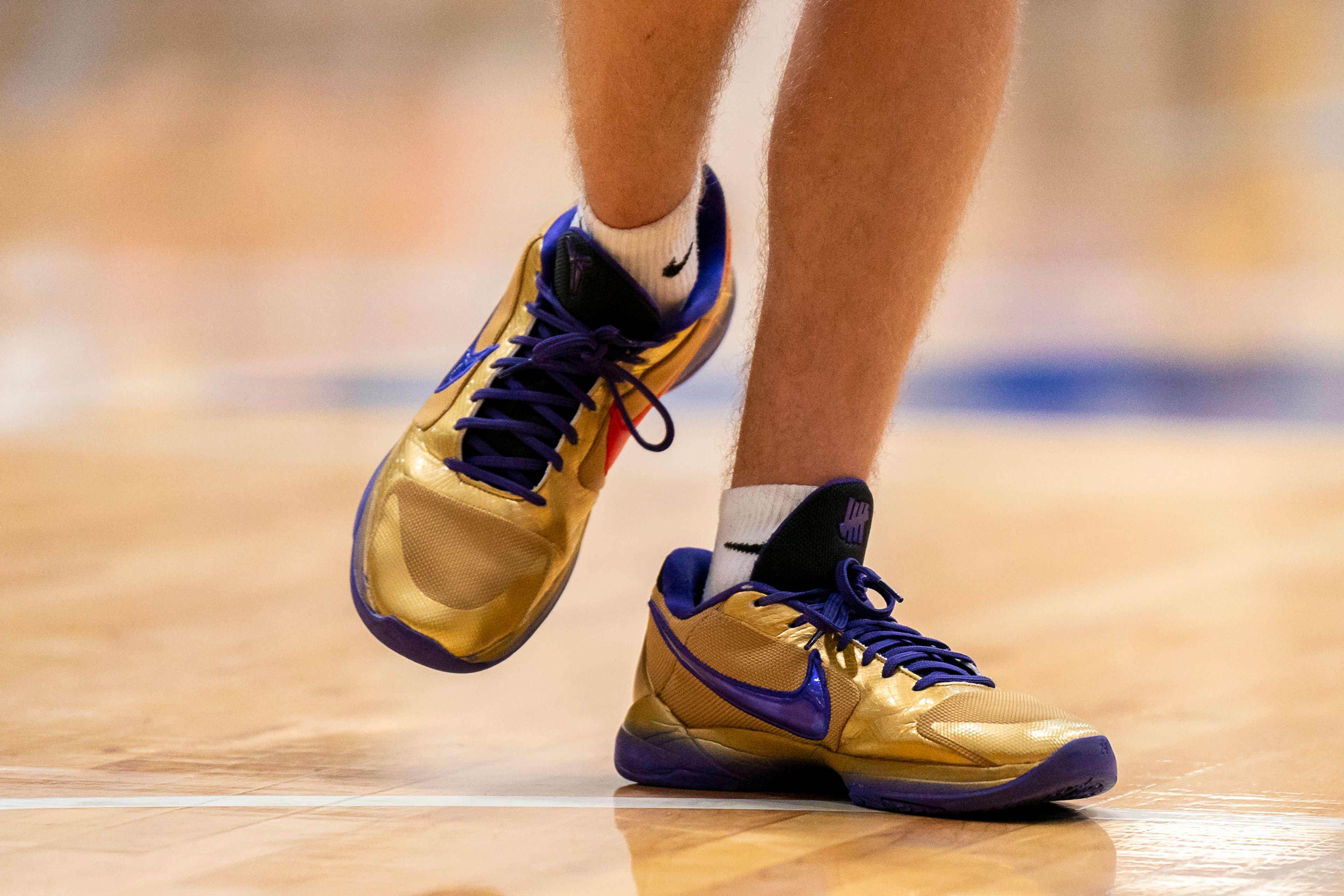 Lewiston’s Jordan Walker wears gold shoes with purple and red-colored logos during their Golden Throne rivalry game against Clarkston on Friday inside the P1FCU Activity Center in Lewiston.