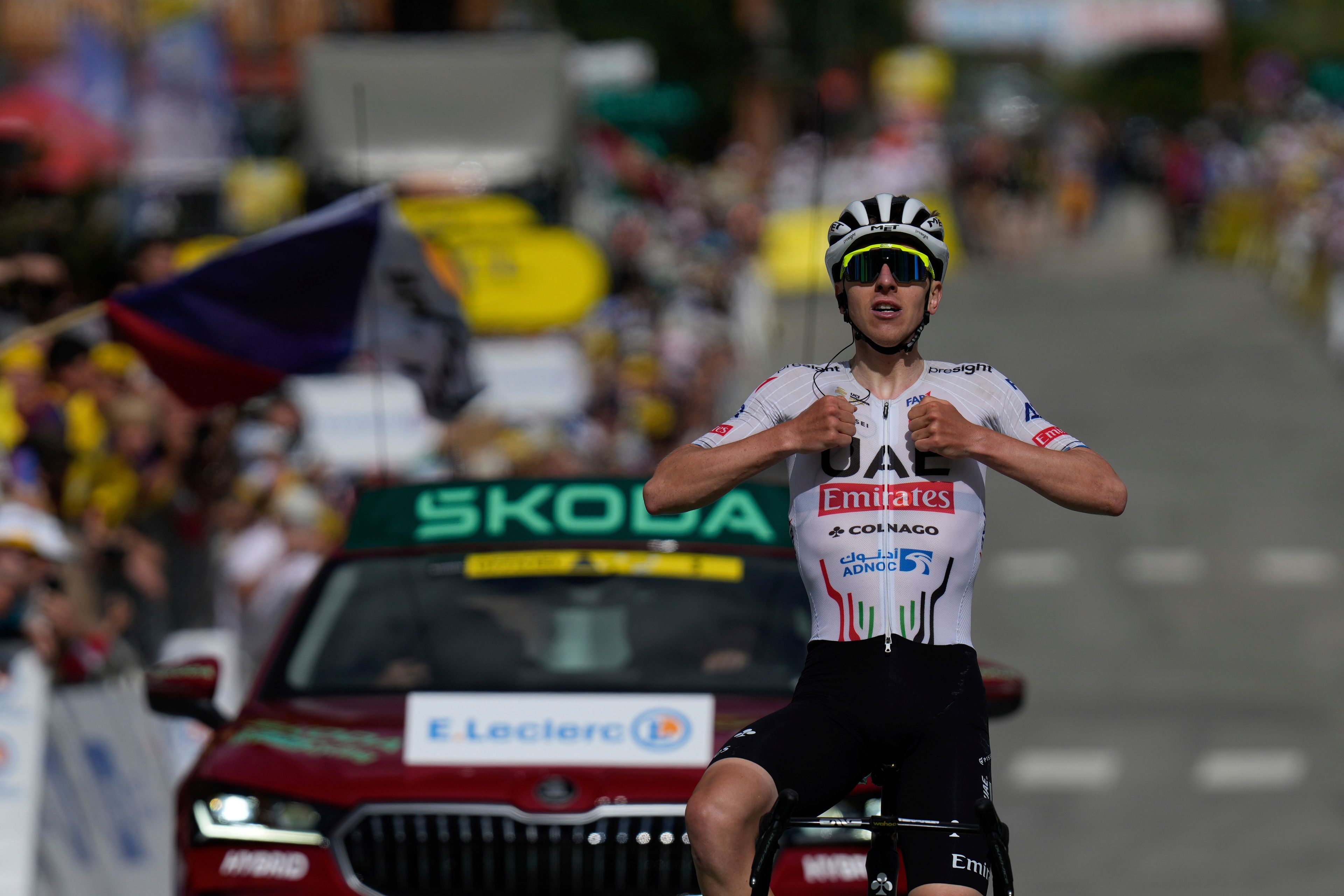 Slovenia's Tadej Pogacar celebrates as he crosses the finish line to win the fourth stage of the Tour de France cycling race over 139.6 kilometers (86.7 miles) with start in Pinerolo, Italy and finish in Valloire, France, Tuesday, July 2, 2024. (AP Photo/Jerome Delay)