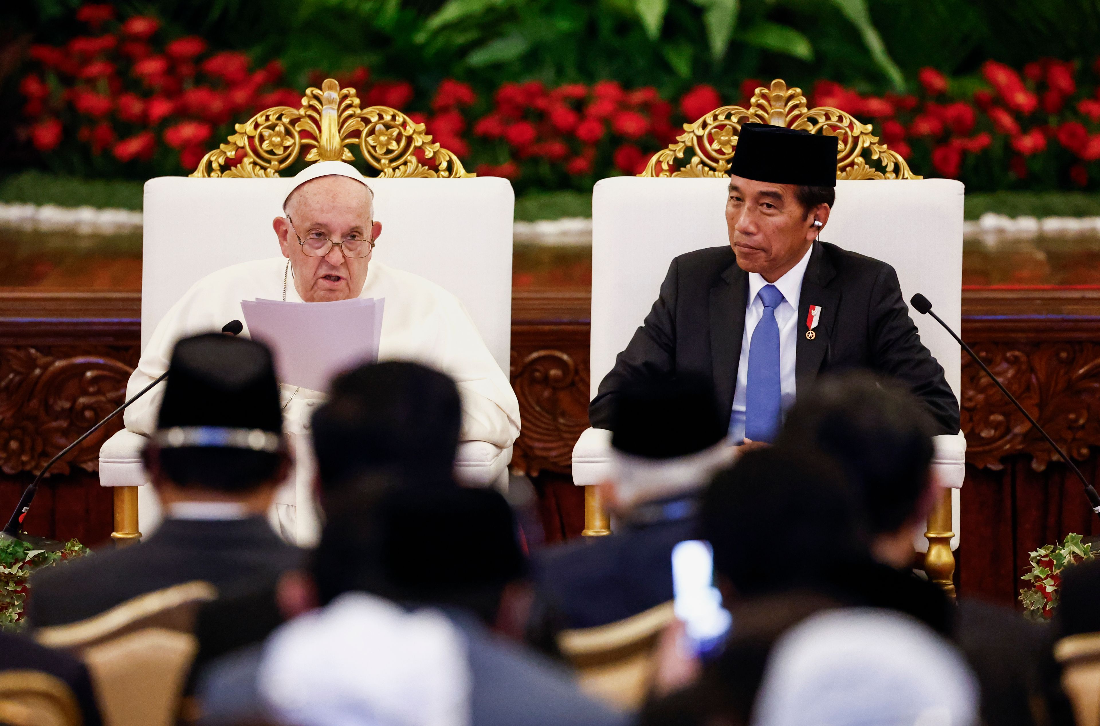 Pope Francis, left, delivers his address as Indonesian President Joko Widodo looks on during a meeting with Indonesian authorities, civil society and the diplomatic corps, during his apostolic visit to Asia, at the Presidential Palace in Jakarta Wednesday, Sept. 4, 2024.