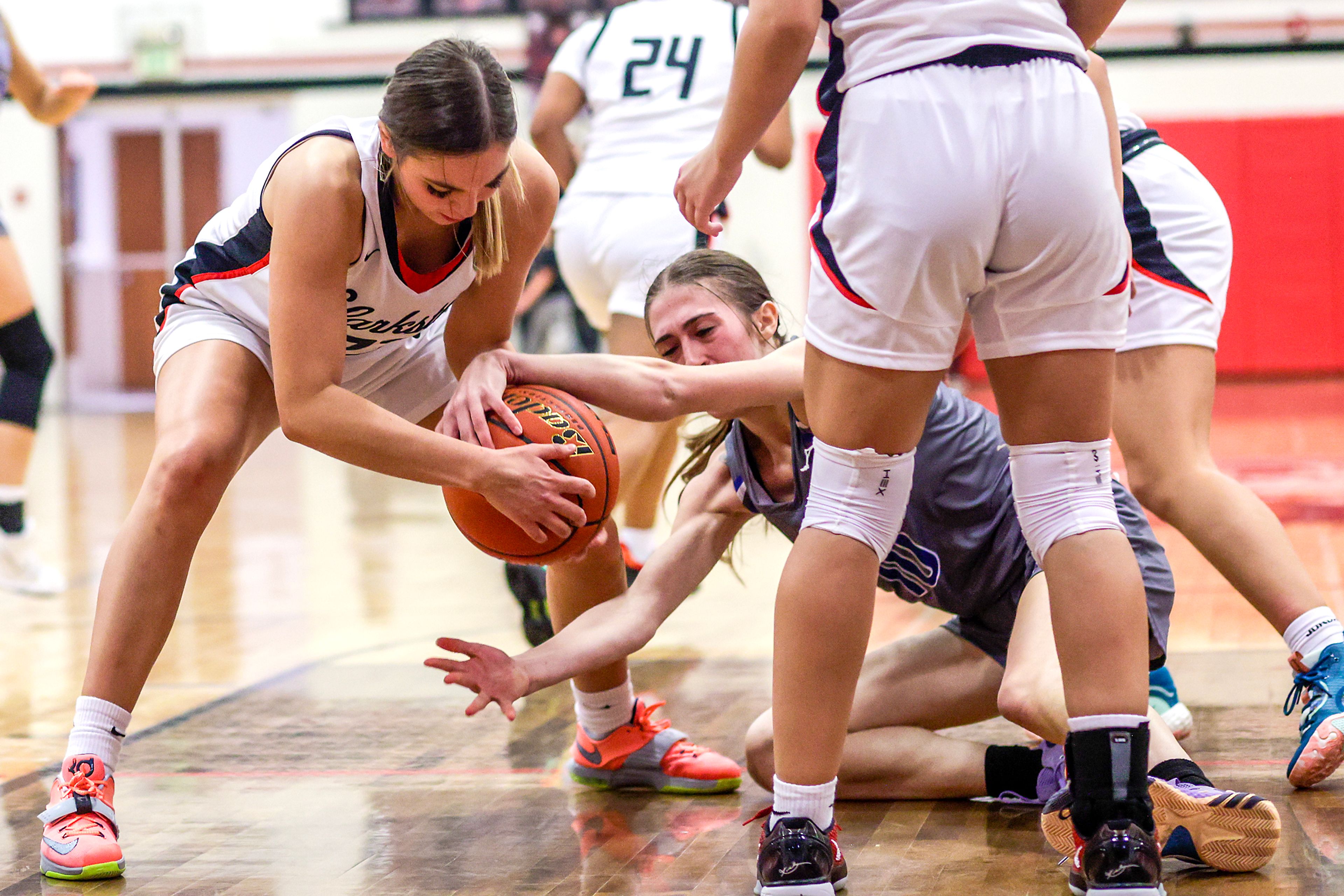 Clarkston wing Alahondra Perez, left, and Pullman guard Lacie Sines wrestle for a loose ball during Tuesday's Class 2A Greater Spokane League girls basketball game.