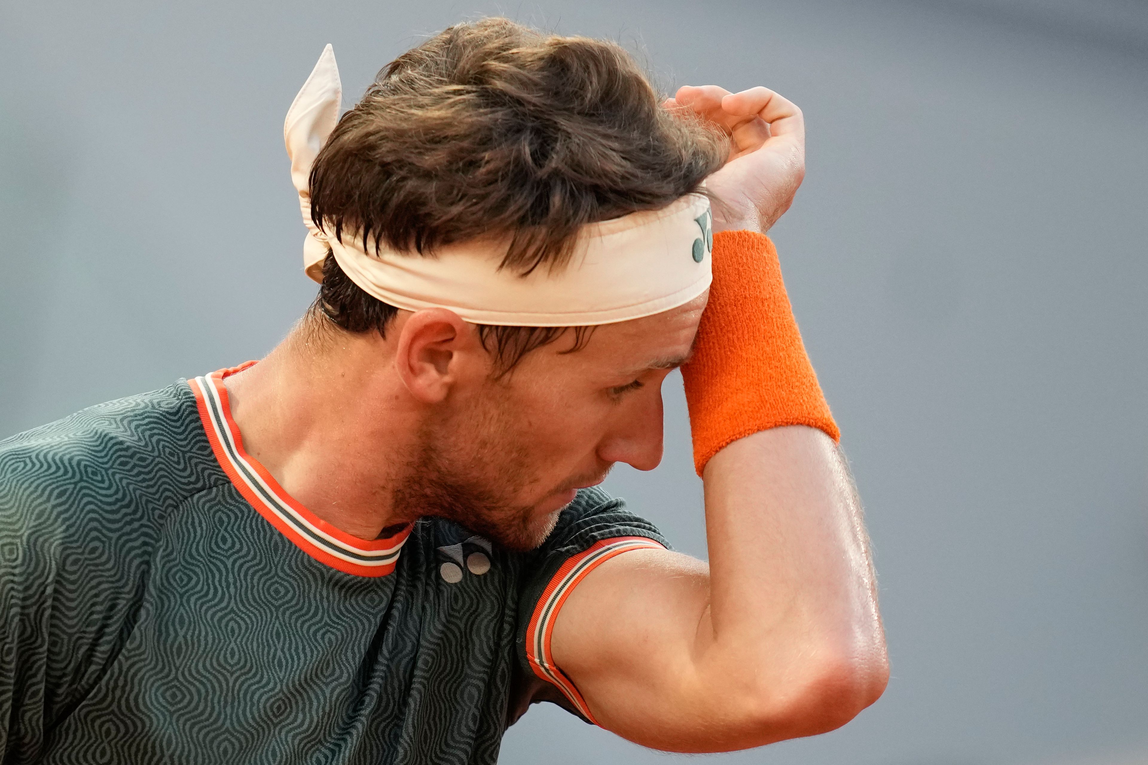 Norway's Casper Ruud wipes the sweat off his face during the semifinal match of the French Open tennis tournament against Germany's Alexander Zverev at the Roland Garros stadium in Paris, Friday, June 7, 2024.