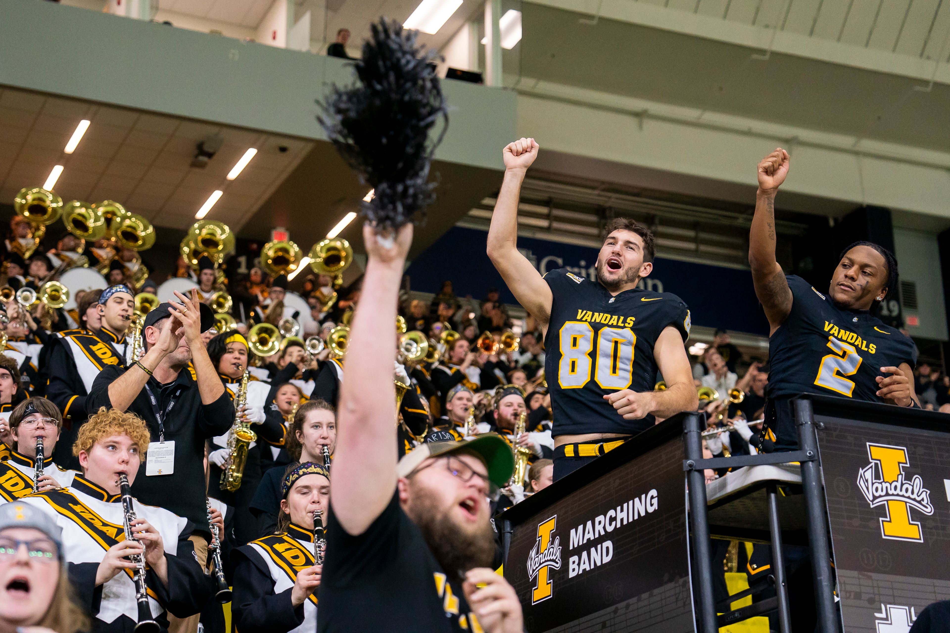 Idaho wide receiver Hayden Hatten (80) and defensive back Marcus Harris (2) preform the Vandal Fight Song with the Vandal marching band after beating Idaho State 62-21 on Nov. 18 at the P1FCU Kibbie Dome in Moscow.