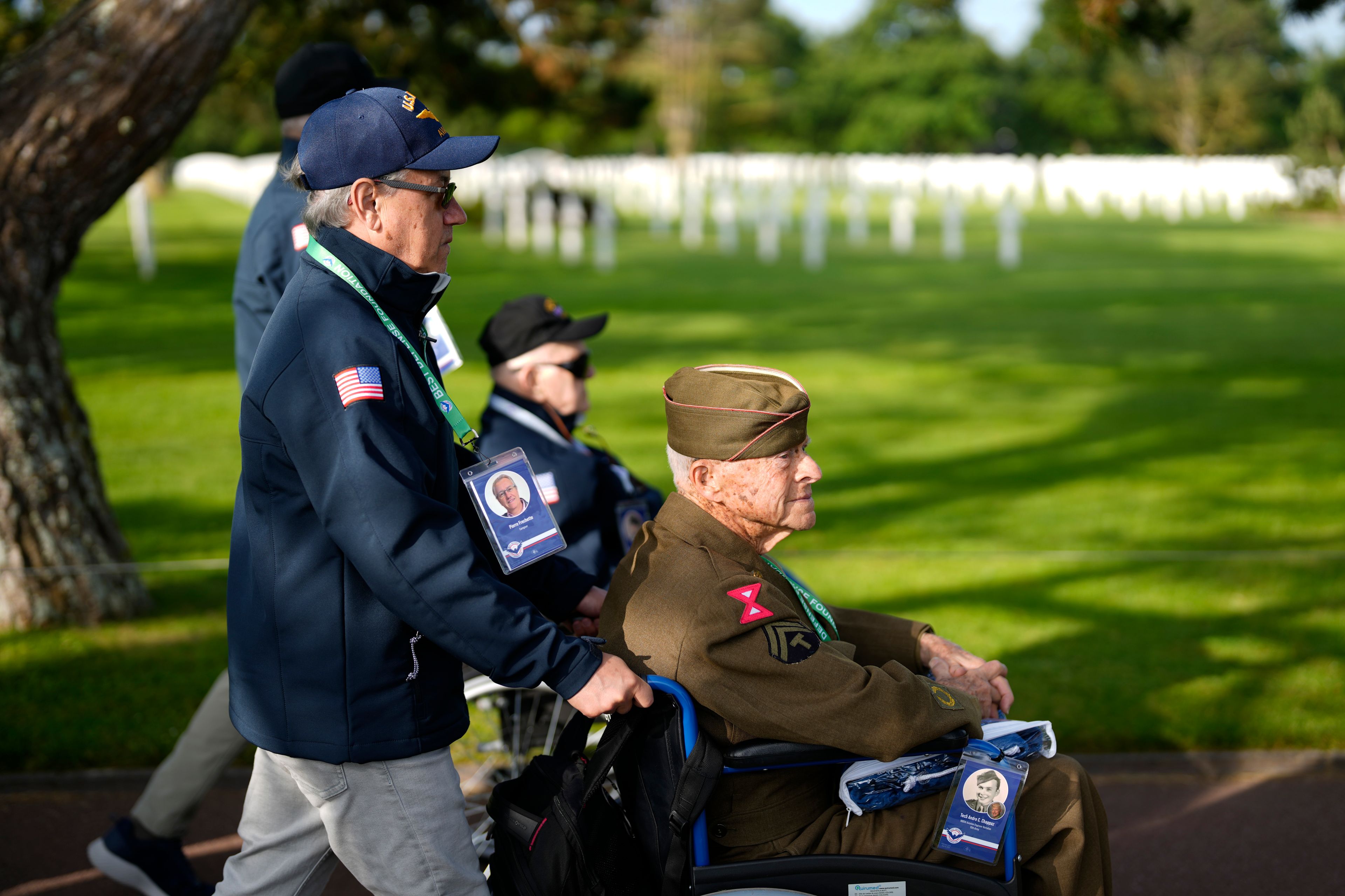 U.S. World War II veteran Andre Chappaz visits graves at the Normandy American Cemetery in Colleville-sur-Mer, France, Tuesday, June 4, 2024. World War II veterans from across the United States as well as Britain and Canada are in Normandy this week to mark 80 years since the D-Day landings that helped lead to Hitler's defeat. (AP Photo/Virginia Mayo)