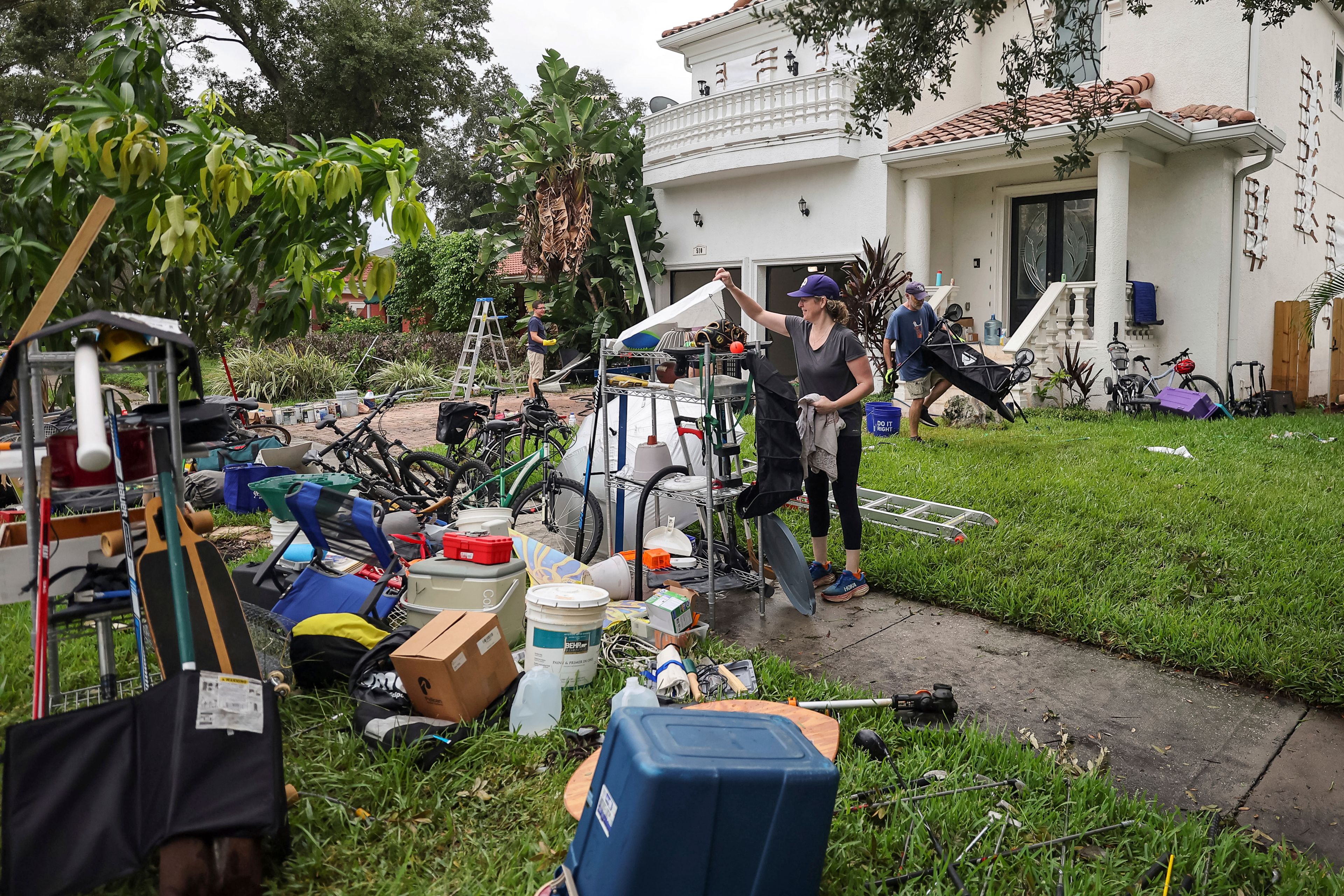 Ellie Moss, along with family and friends cleans contents of her home after flooding from Hurricane Helene on Davis Island Saturday, Sept. 28, 2024, in Tampa, Fla. (AP Photo/Mike Carlson)