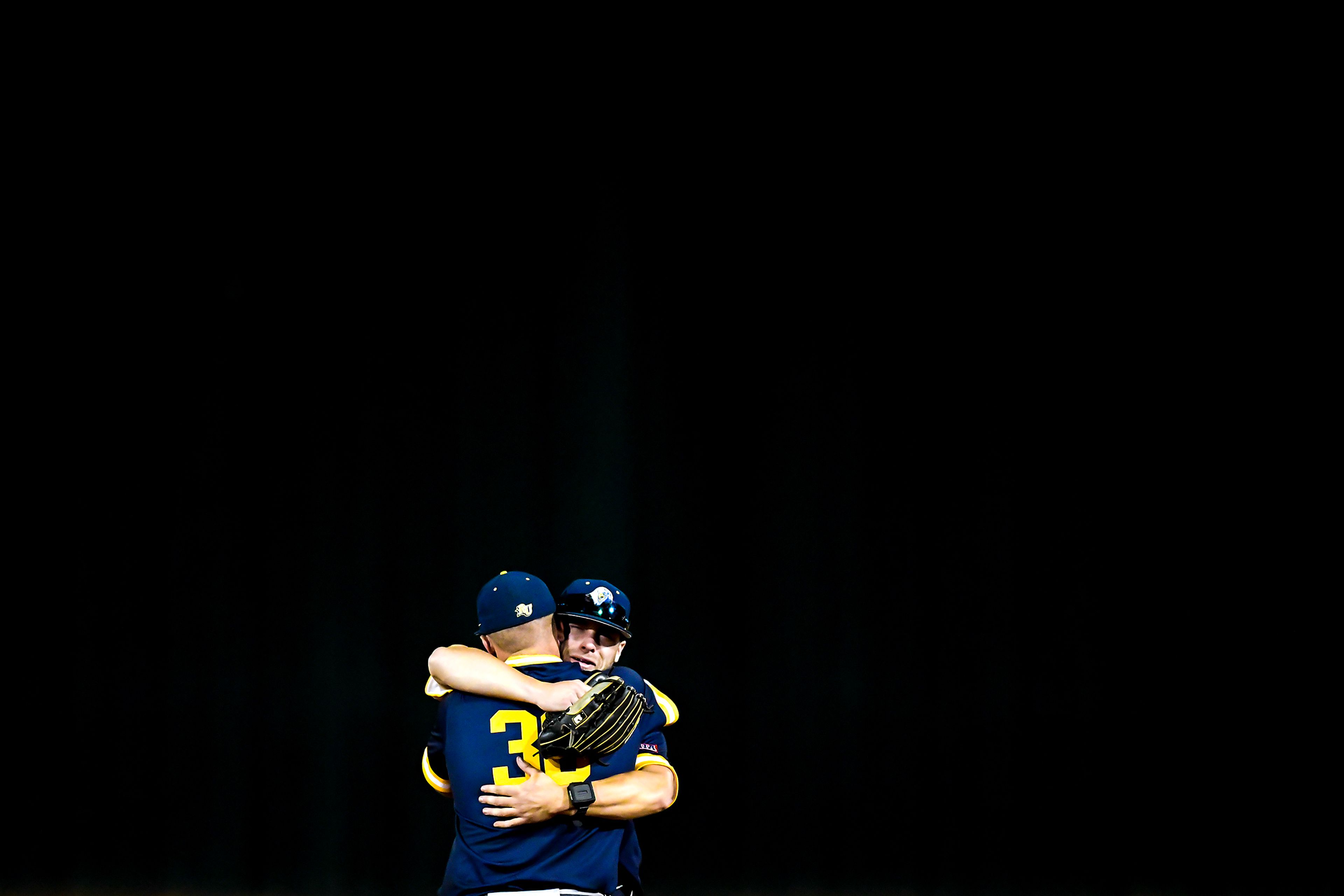 Reinhardt’s Lance Dockery is comforted by a teammate after their loss to Tennessee Wesleyan in Game 18 of the NAIA World Series at Harris Field Thursday in Lewiston.