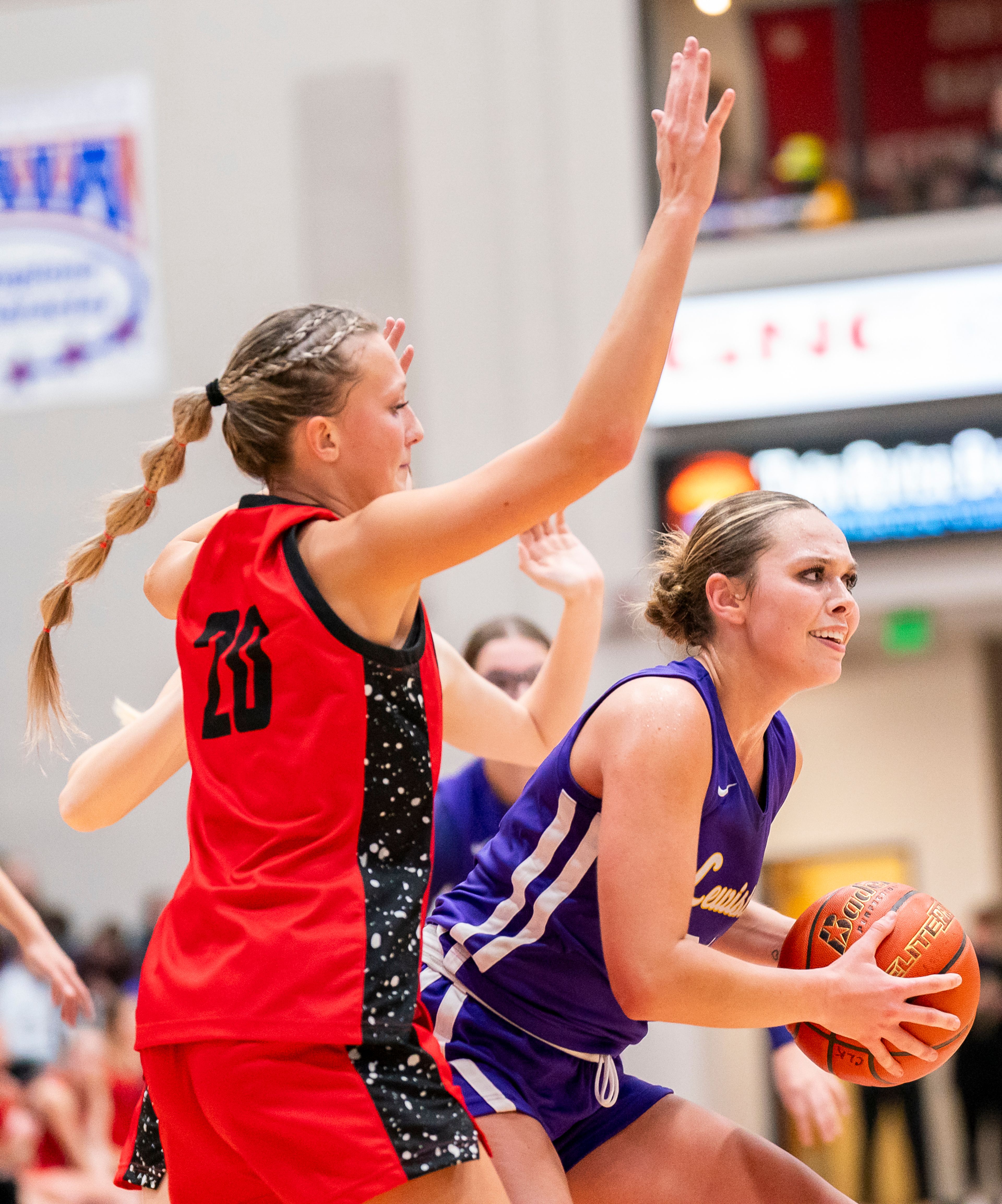 Lewiston’s Reese Degroot, right, looks to pass the ball during their Golden Throne rivalry game against Clarkston on Friday inside the P1FCU Activity Center in Lewiston.