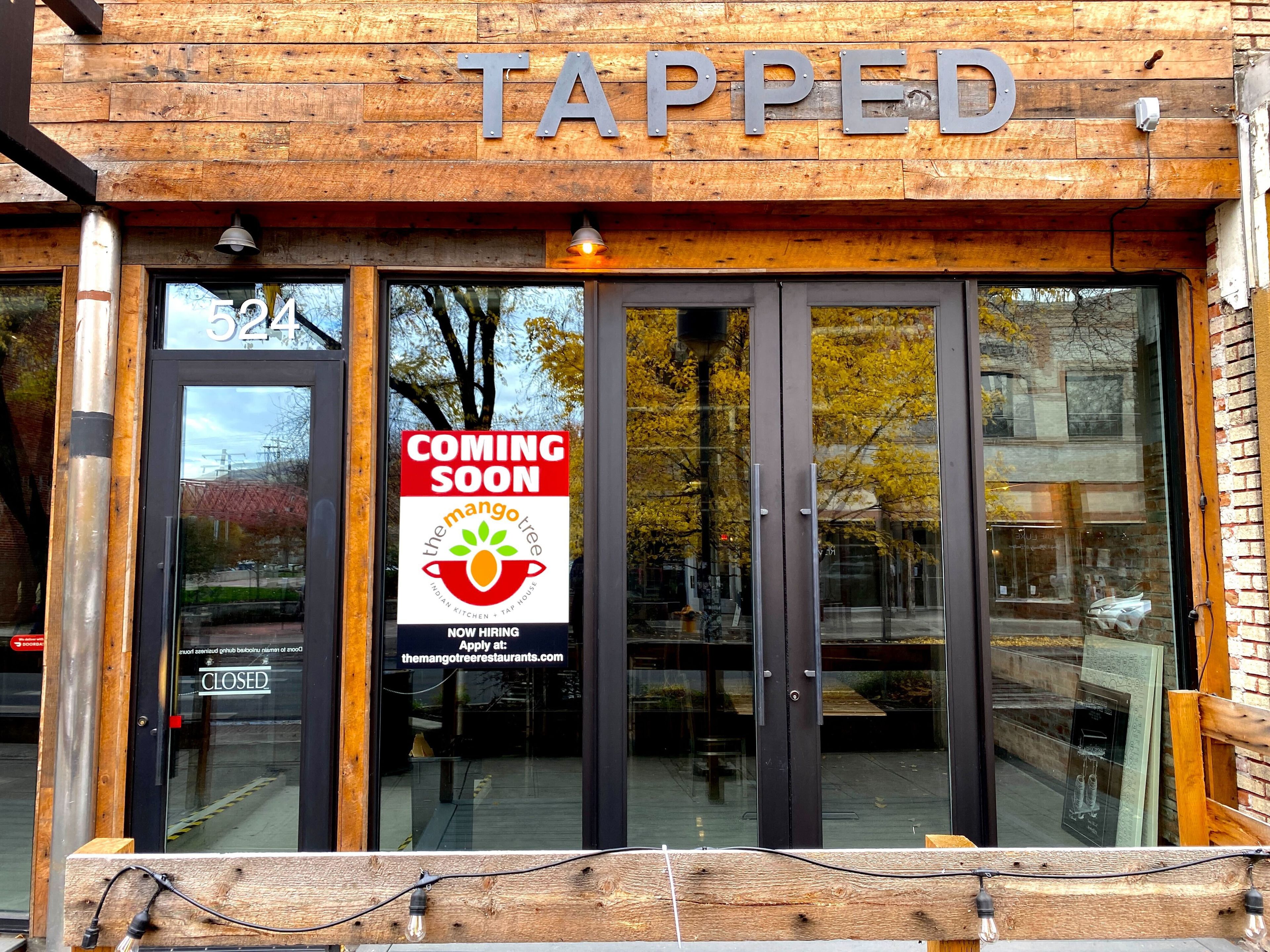 A "Coming Soon" sign hangs in the window of the former Tapped location at  524 Main St., Lewiston. The sign announces The Mango Tree Indian Kitchen and Tap House is planning to open at location at that space.