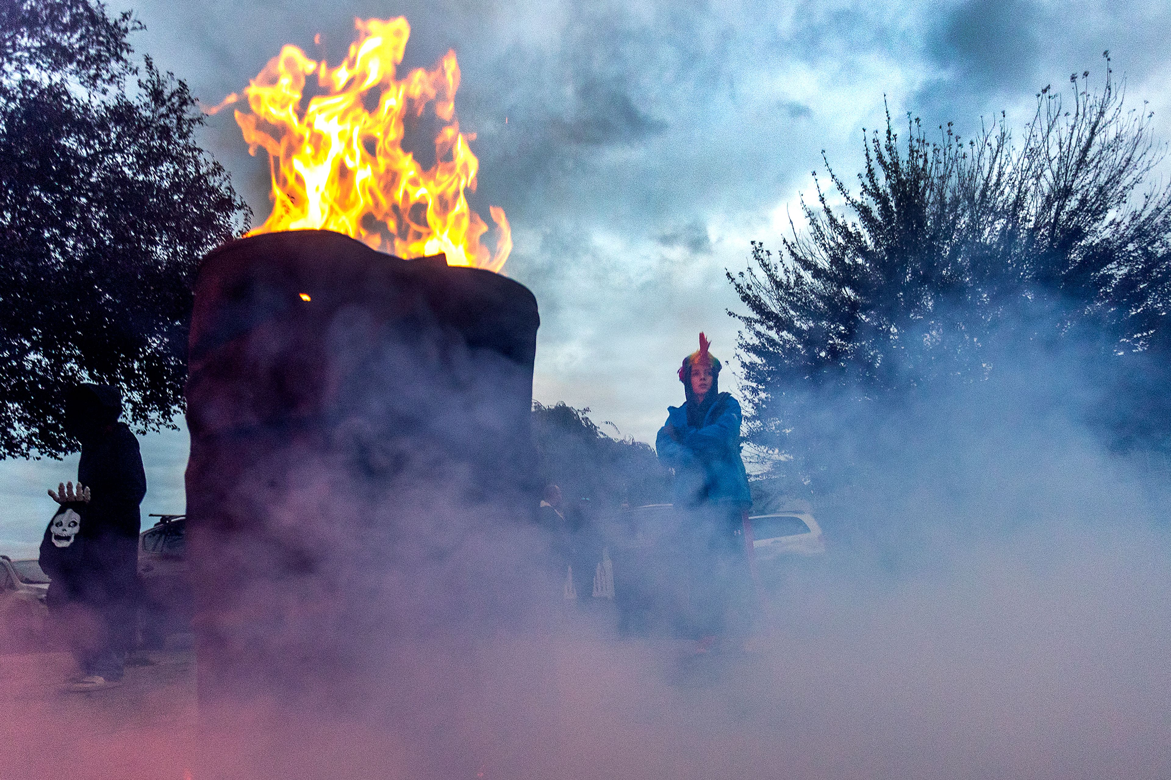 Smoke from a fog machine fills the Air as a fire burns in a barrel on Halloween at the Birch neighborhood in the Lewiston Orchards on Monday.