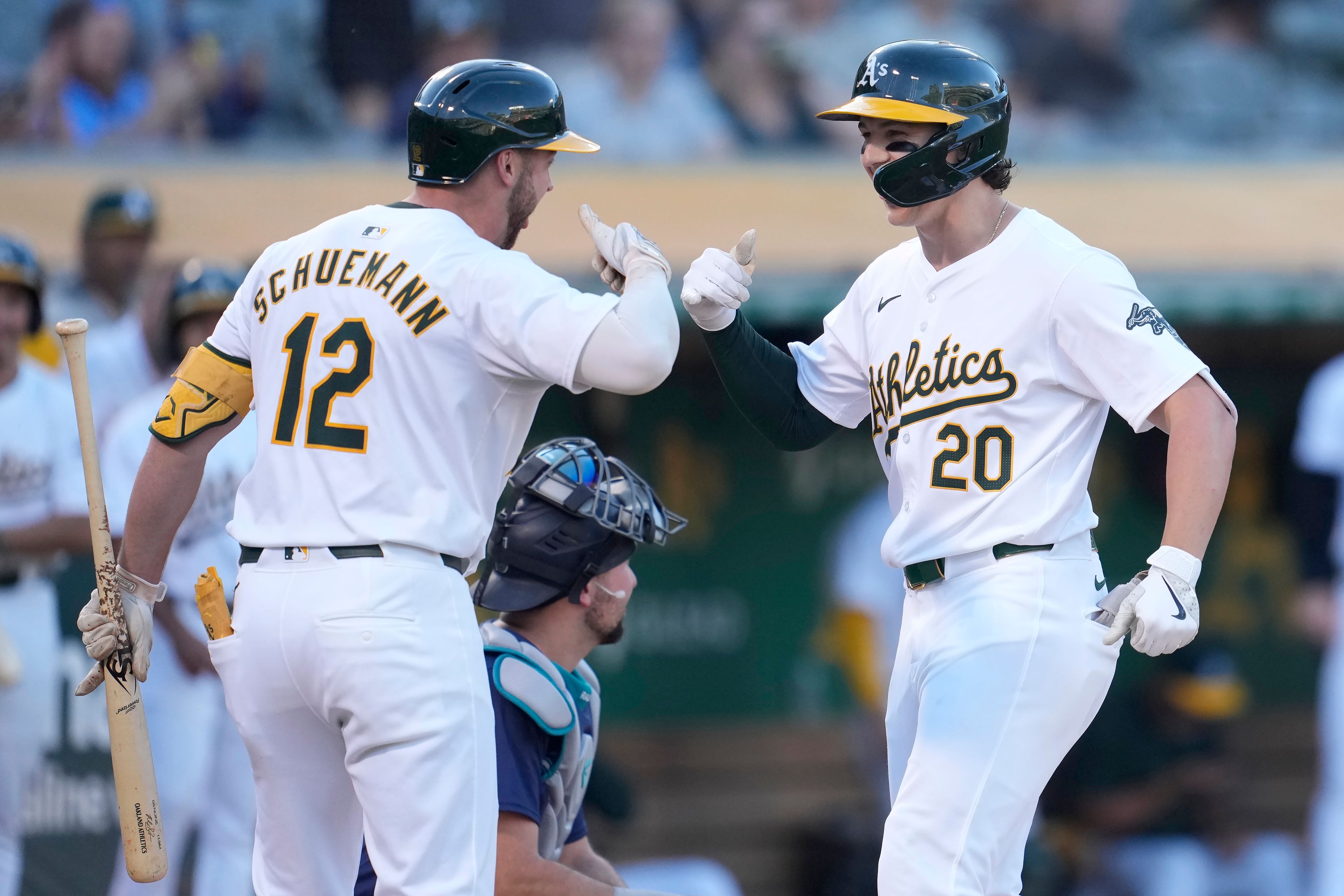 Oakland Athletics' Zack Gelof (20) is congratulated by Max Schuemann (12) after hitting a home run against the Seattle Mariners during the third inning of a baseball game in Oakland, Calif., Wednesday, June 5, 2024. (AP Photo/Jeff Chiu)