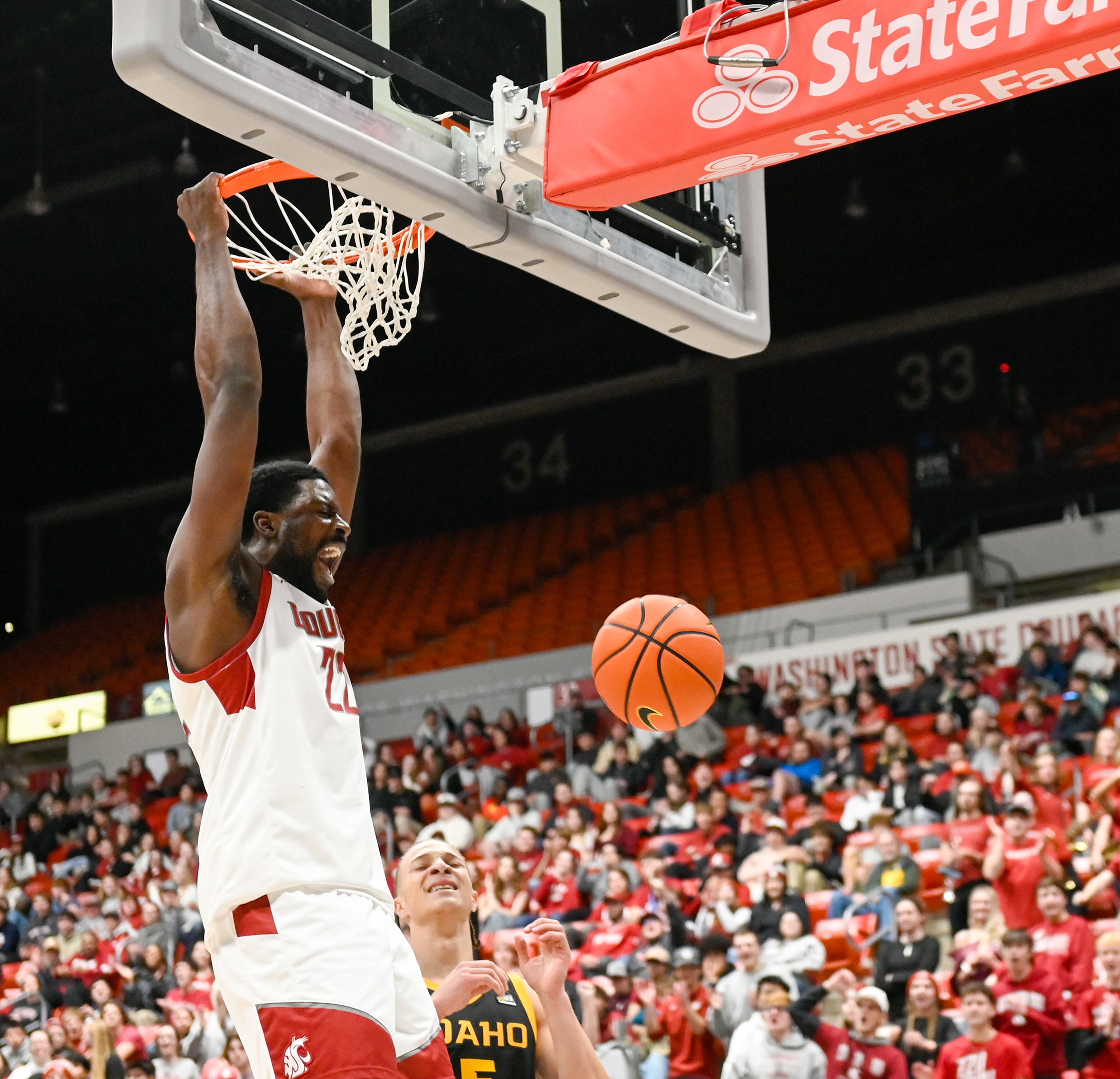 Washington State forward ND Okafor celebrates a slam dunk while holding on to the rim Monday during the Battle of the Palouse against Idaho at Beasley Coliseum in Pullman.