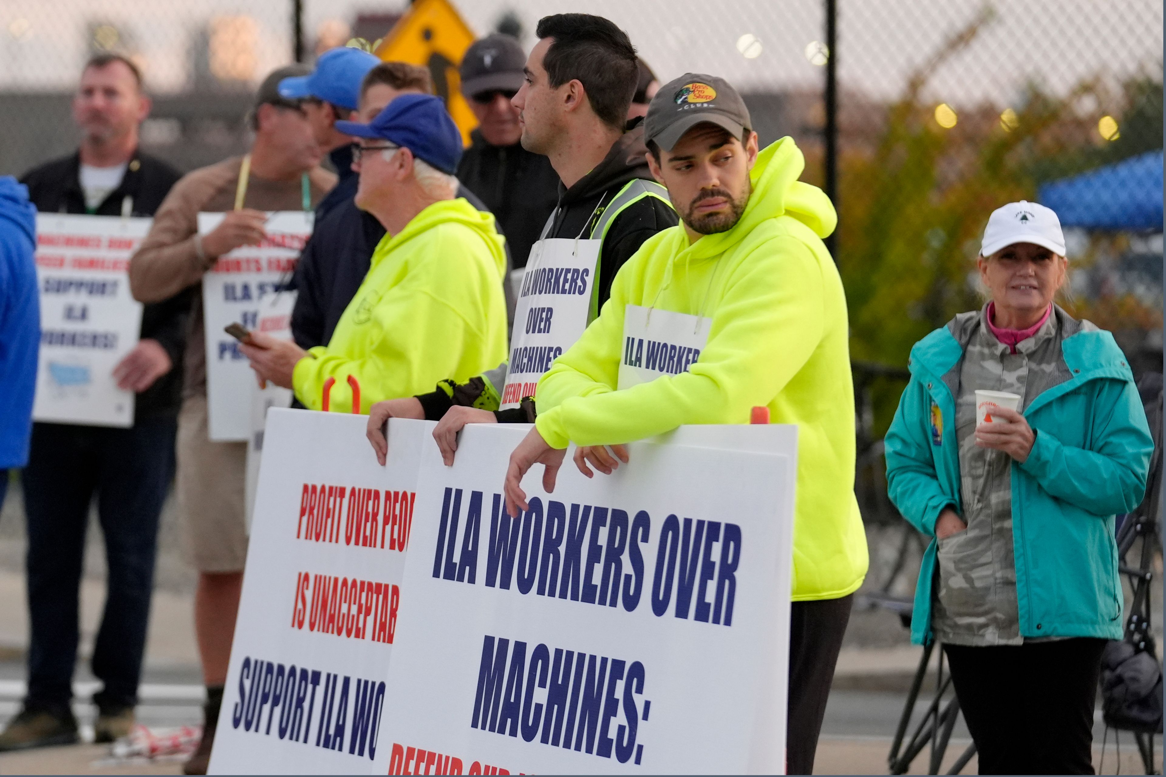 Dockworkers strike in front an entrance to a container terminal near Boston Harbor, Tuesday, Oct. 1, 2024, in Boston. (AP Photo/Steven Senne)