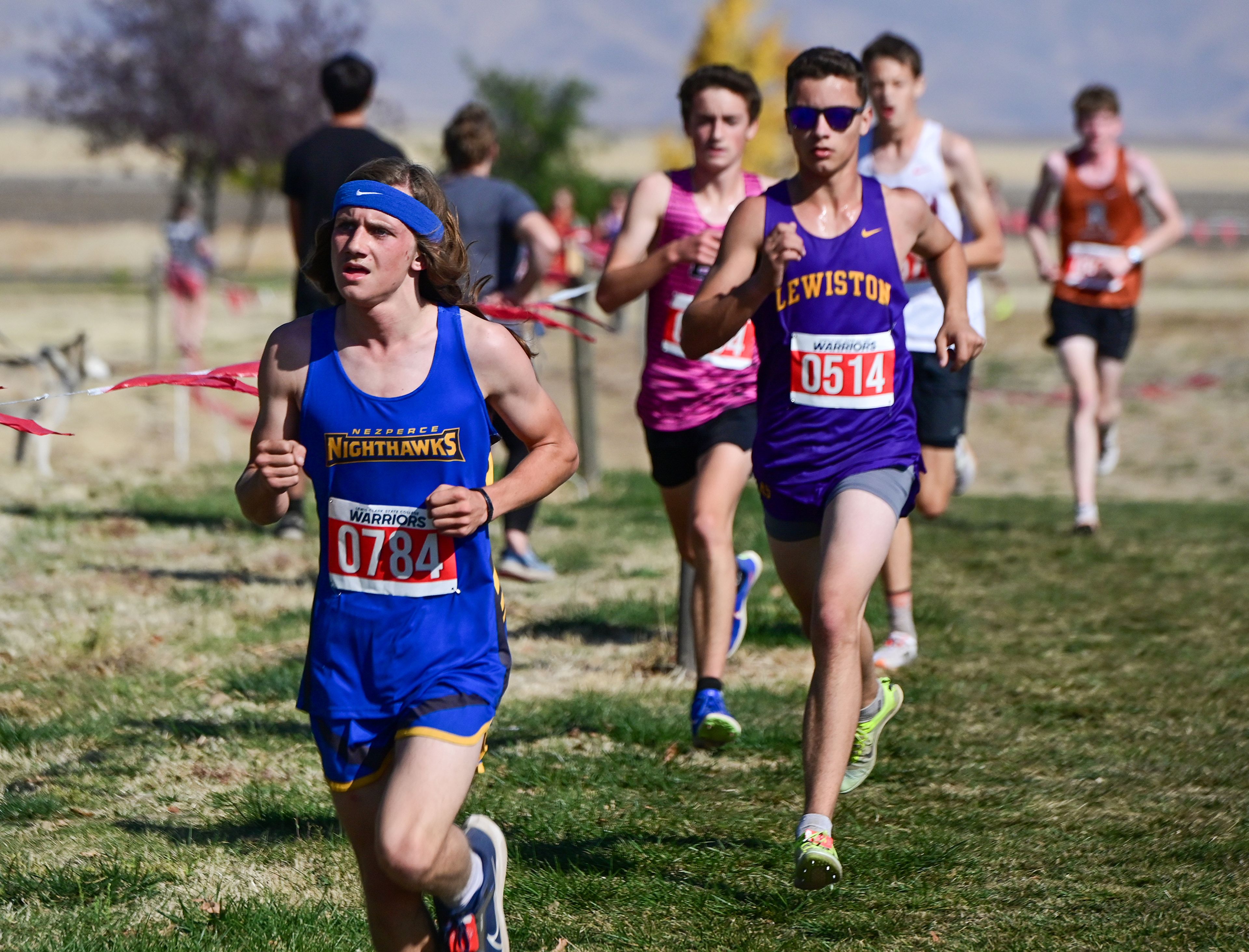 Nezperce's Blayne Mosman, left, and Lewiston's Lee Miller compete in the Inland Empire Championships varsity boys 5K Saturday along the LCSC XC Course in Lewiston.,