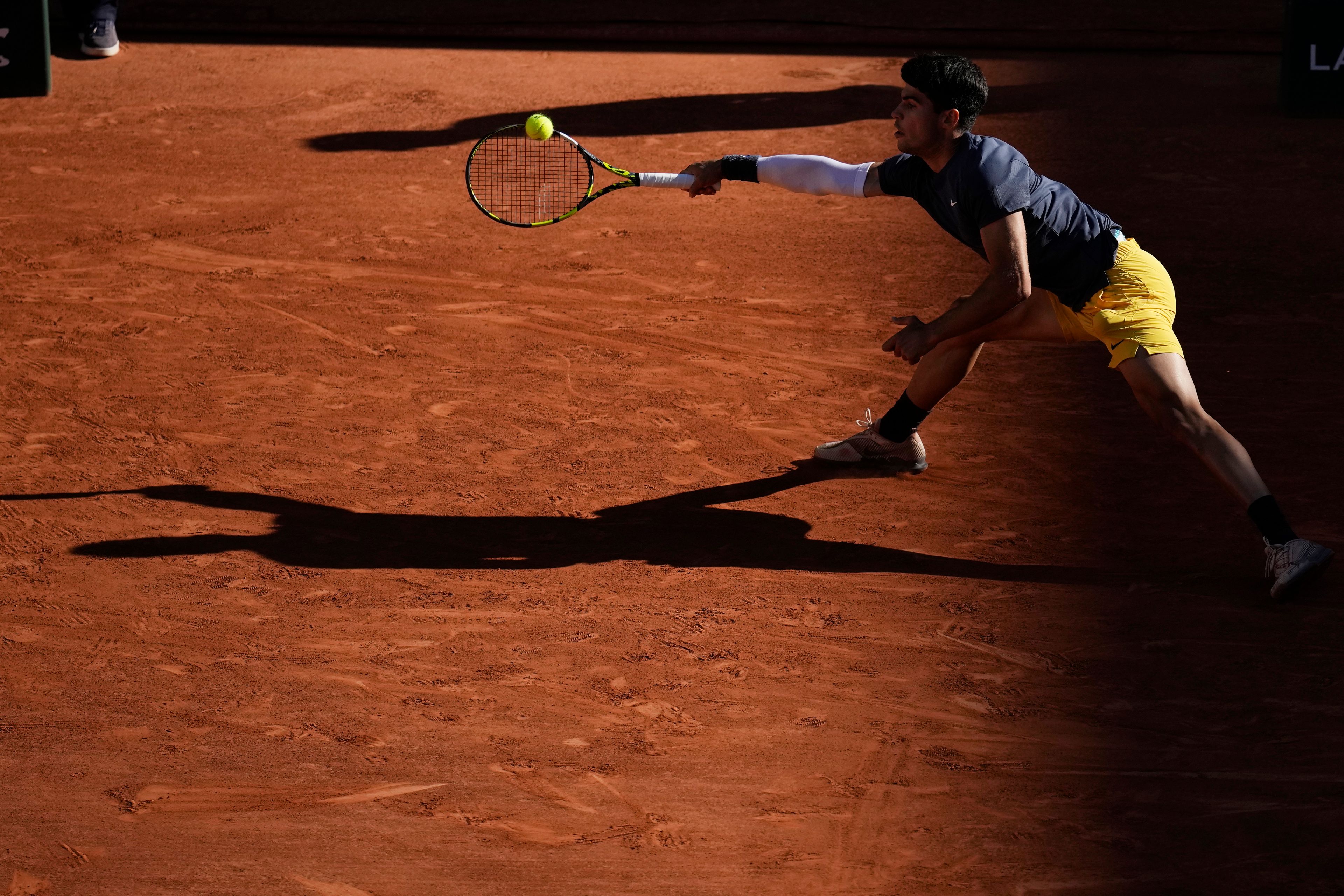 Spain's Carlos Alcaraz plays a shot against Italy's Jannik Sinner during their semifinal match of the French Open tennis tournament at the Roland Garros stadium in Paris, Friday, June 7, 2024.