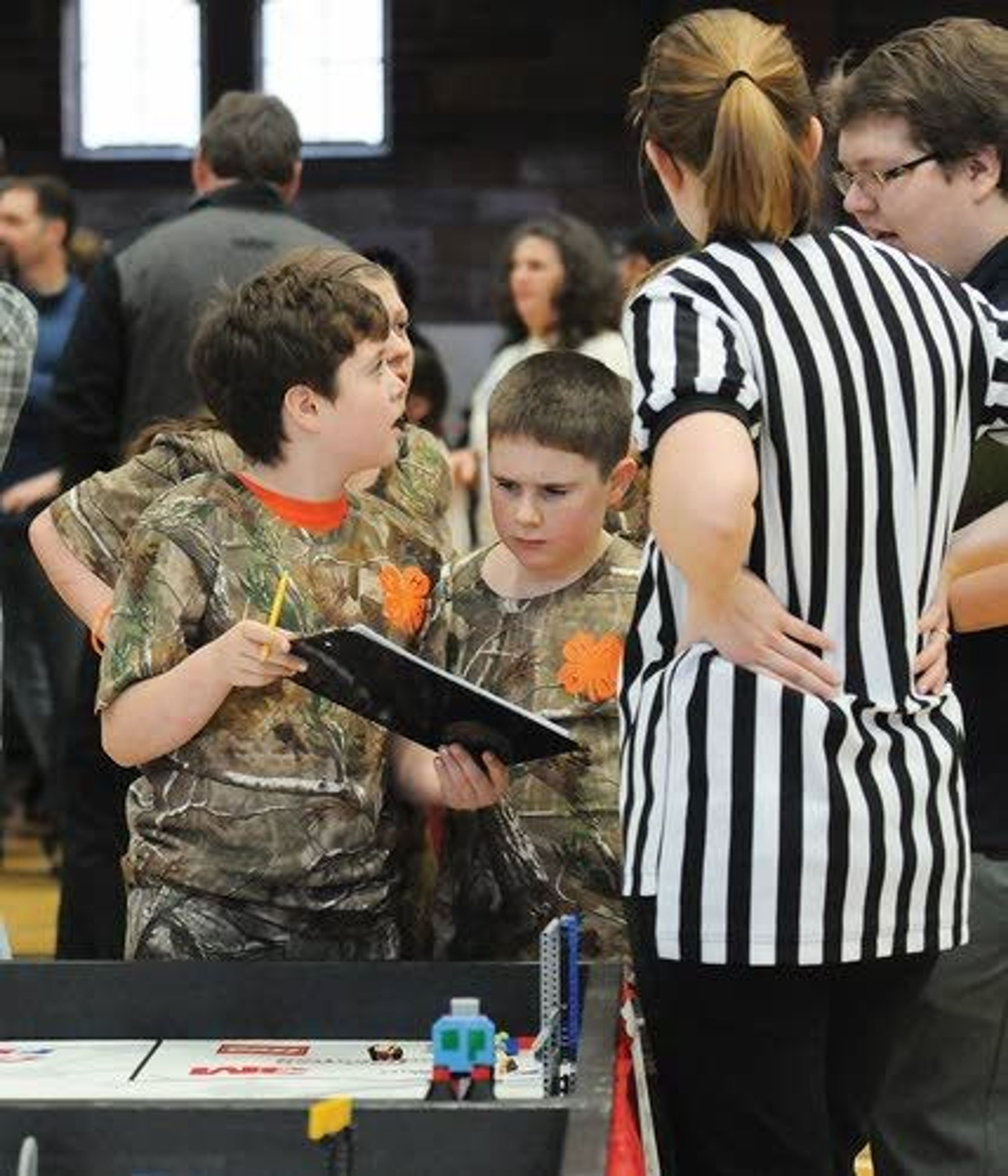 The Camouflage Squirrel Association team from Grangeville goes over its score with judges during the competition at the University of Idaho Saturday.