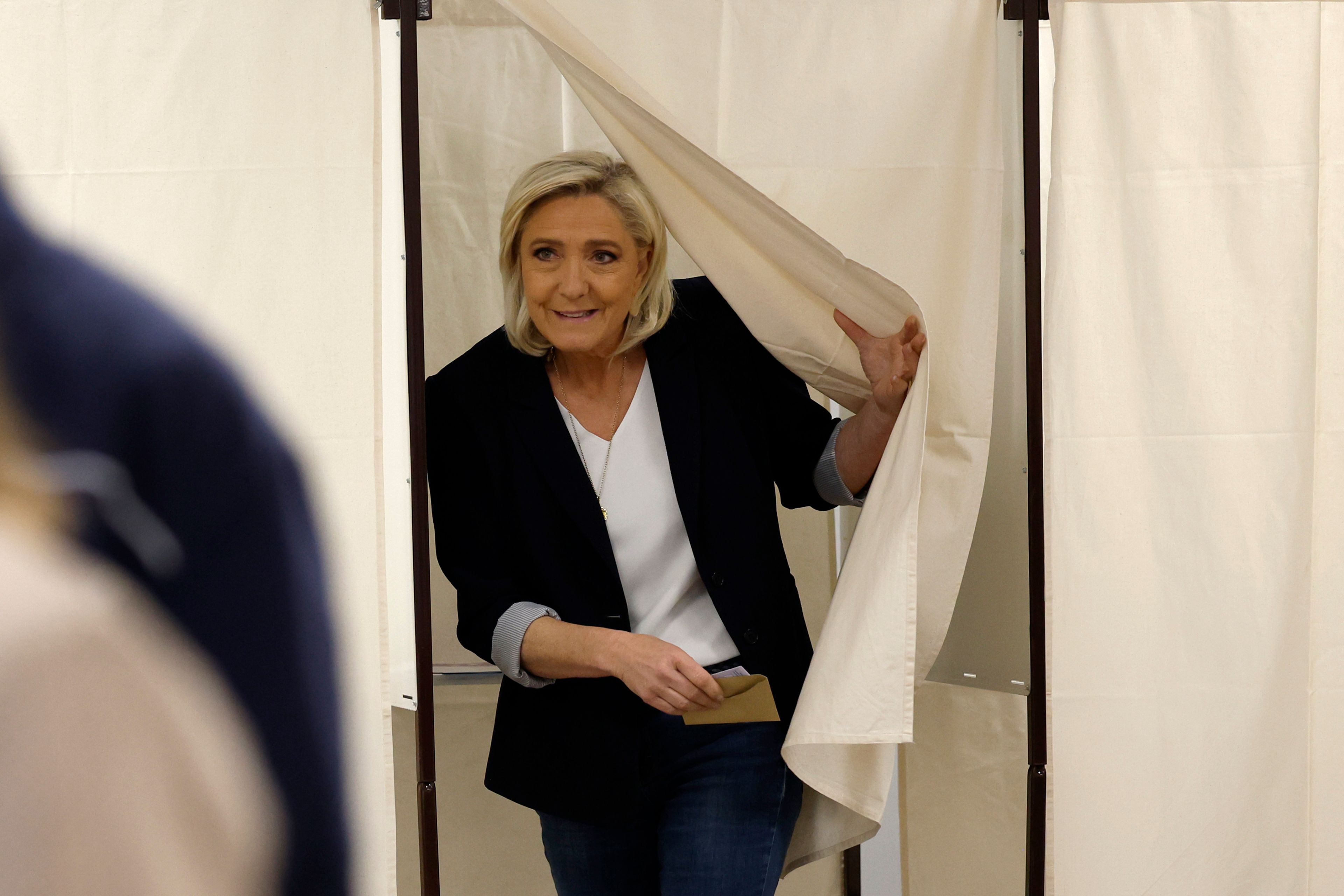 French far-right leader Marine Le Pen exits the voting booth before voting for the European election, Sunday, June 9, 2024 in Henin-Beaumont, northern France. Polling stations opened across Europe on Sunday as voters from 20 countries cast ballots in elections that are expected to shift the European Union's parliament to the right and could reshape the future direction of the world's biggest trading bloc.