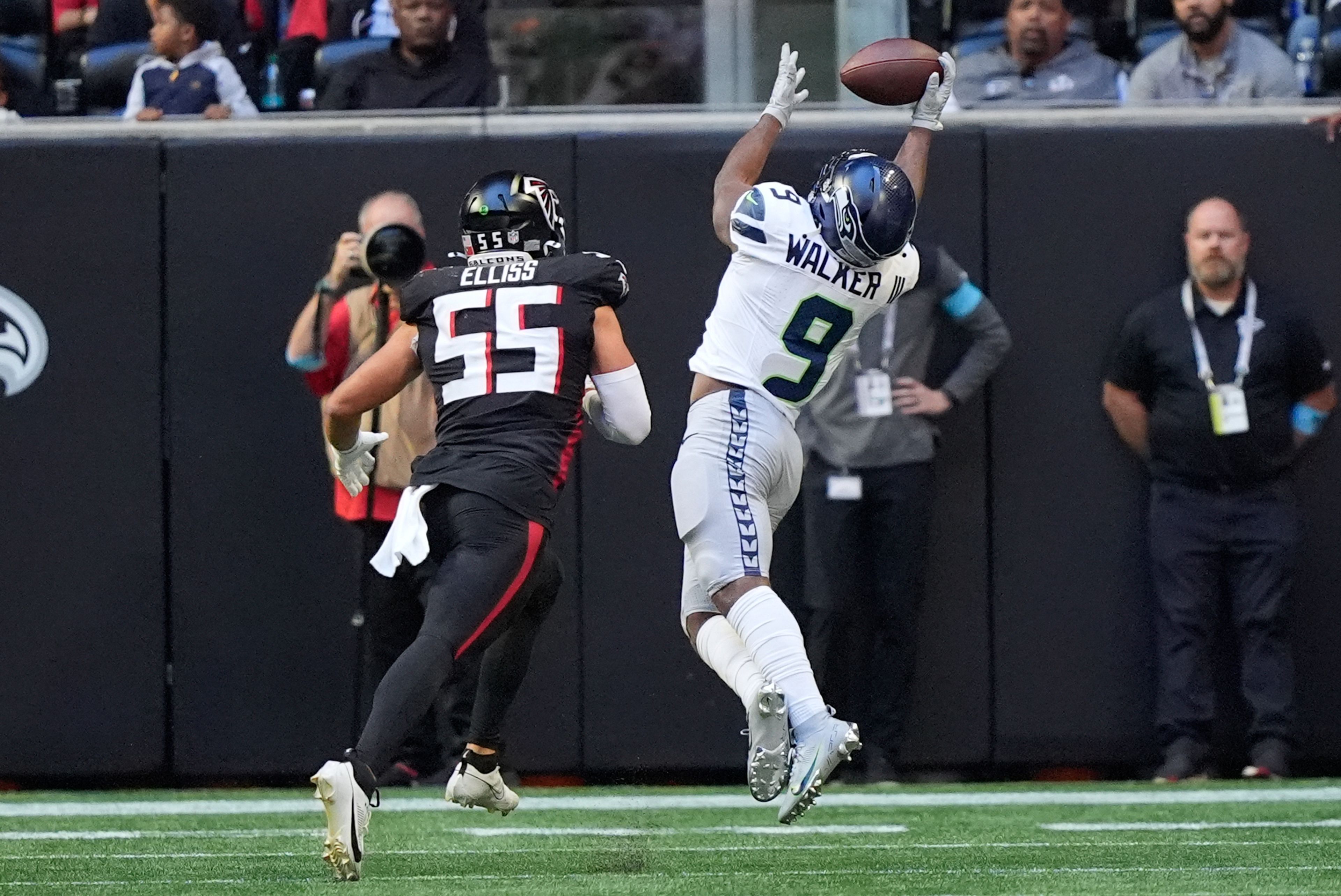 Seattle Seahawks running back Kenneth Walker III (9) makes a catch for a touchdown as Atlanta Falcons linebacker Kaden Elliss (55) defends during the second half of an NFL football game, Sunday, Oct. 20, 2024, in Atlanta. (AP Photo/ Brynn Anderson)