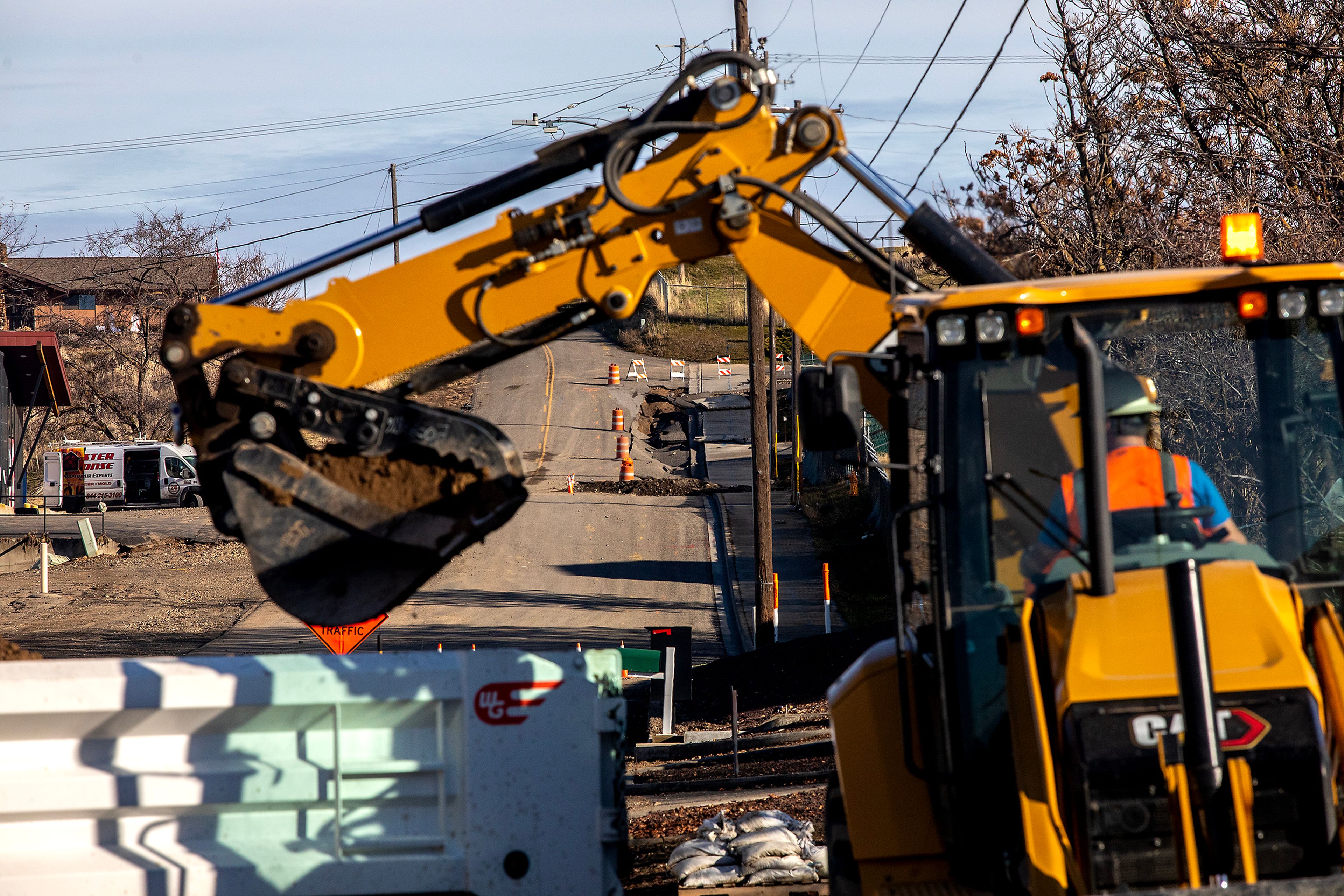 Dirt is moved to a truck along 16th Avenue where flooding occurred last week, Monday in Lewiston.