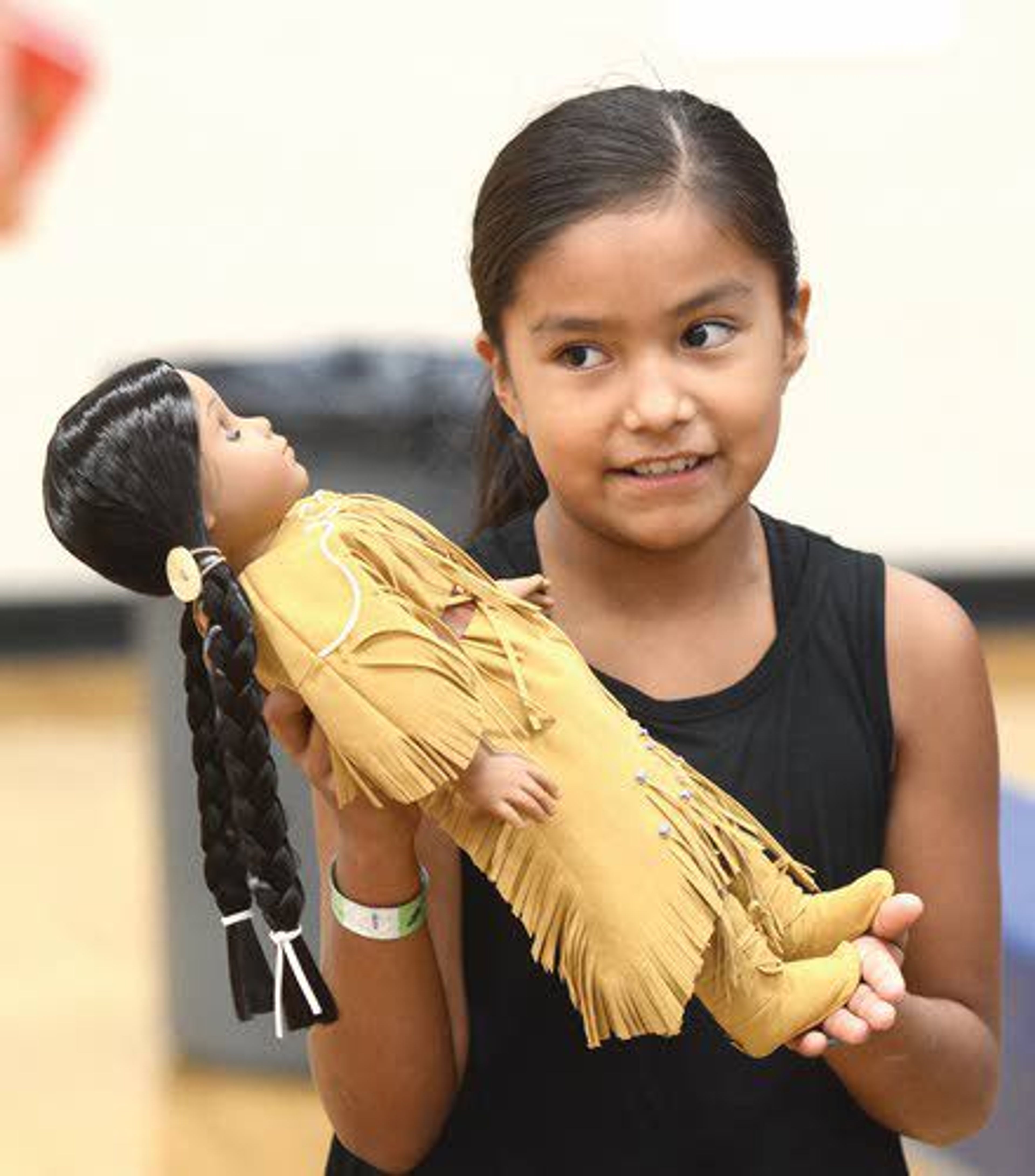 Madden Bisbee, 9, of Lapwai, cradles the Kaya doll she received at the 15th anniversary celebration of the American Girl doll and books based on the Nez Perce Tribe’s history.