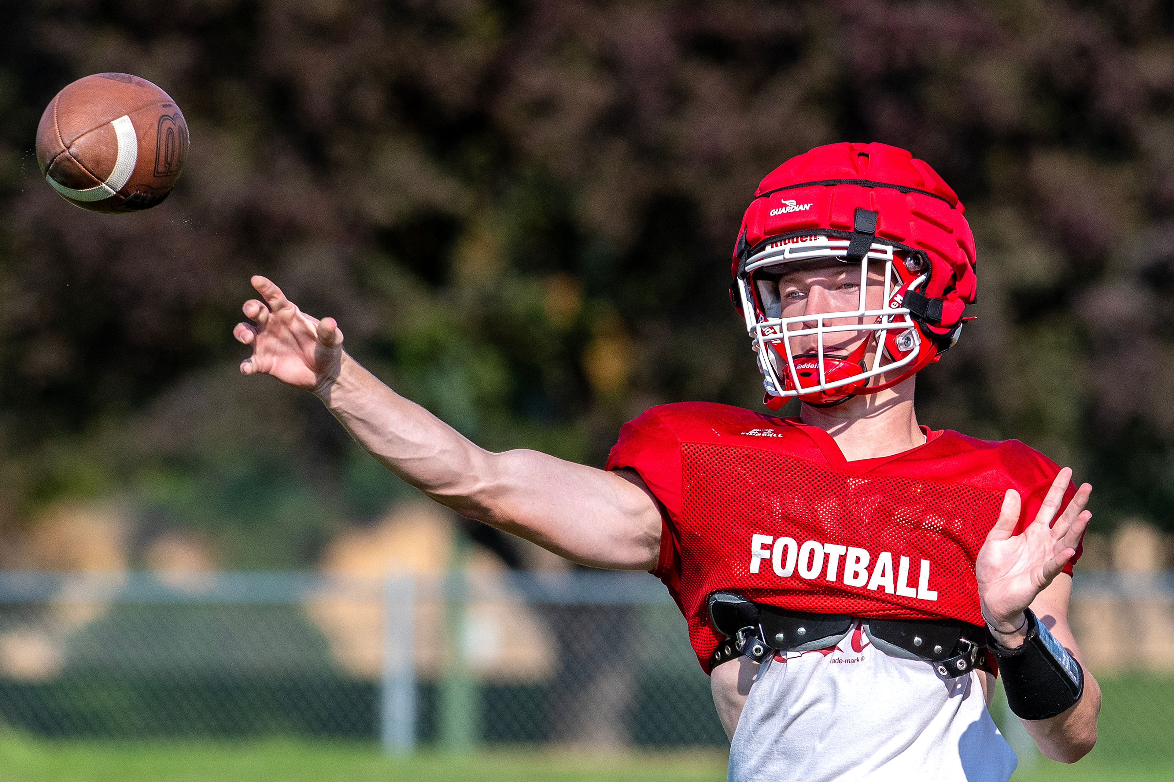 Quarterback Hayden Line throws a pass at football practice Tuesday in Clarkston.