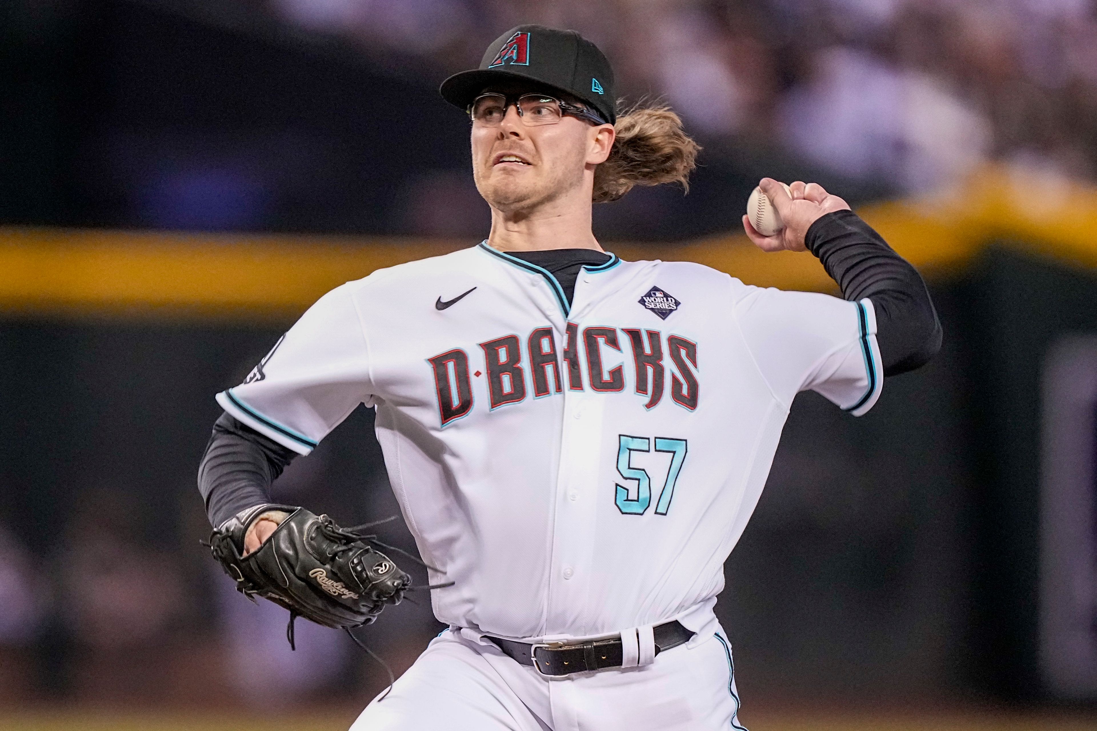 FILE - Arizona Diamondbacks relief pitcher Andrew Saalfrank throws against the Texas Rangers during the ninth inning in Game 3 of the baseball World Series Monday, Oct. 30, 2023, in Phoenix. Major League Baseball, on Tuesday, June 4, 2024, banned Saalfrank for one year after finding the player placed unrelated bets with a legal sportsbook.