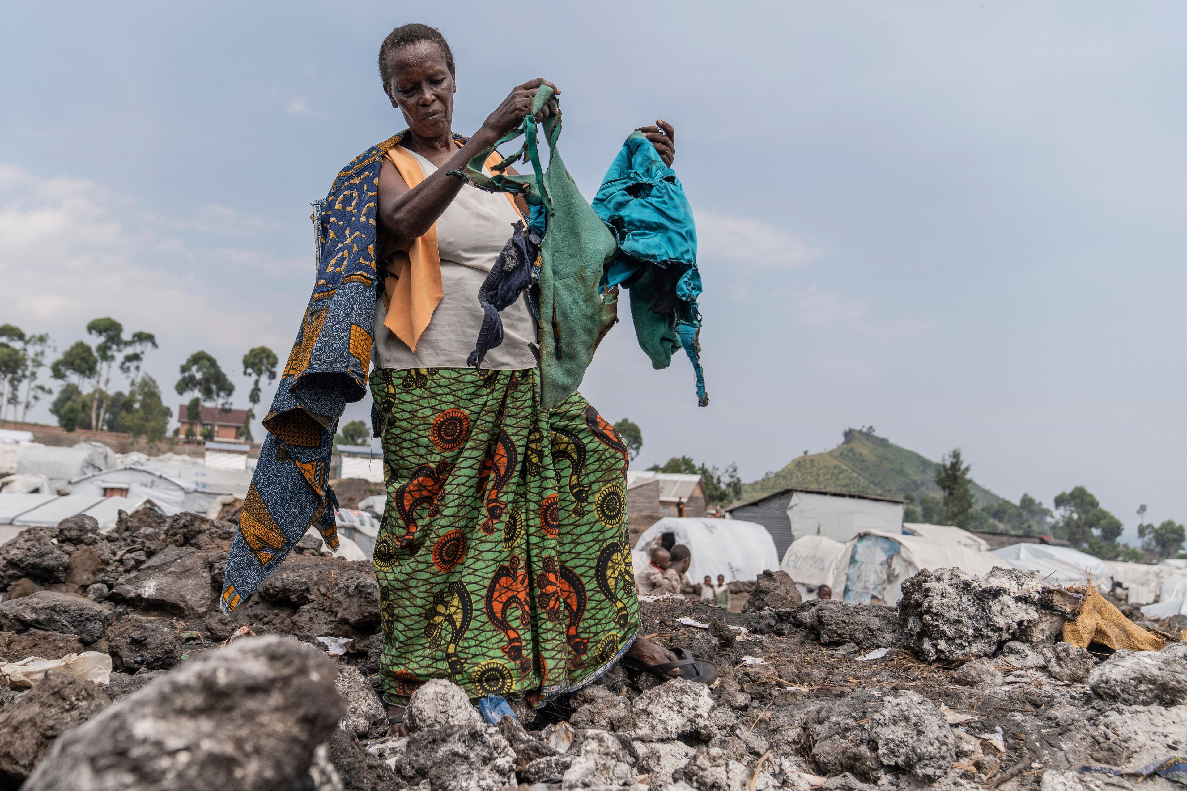 Anne Marie Nikuze, 60, a displaced person living in the Muganga camp with her children and grandchildren near Goma, Democratic republic of the Congo, gathers belongings on Thursday, June 6, 2024. A fire at a displacement camp in eastern Congo has destroyed around 50 makeshift tents, leaving dozens of families without shelter. On Wednesday afternoon, the tents were reduced to ashes at the Mugunga displaced people camp near the provincial capital Goma.