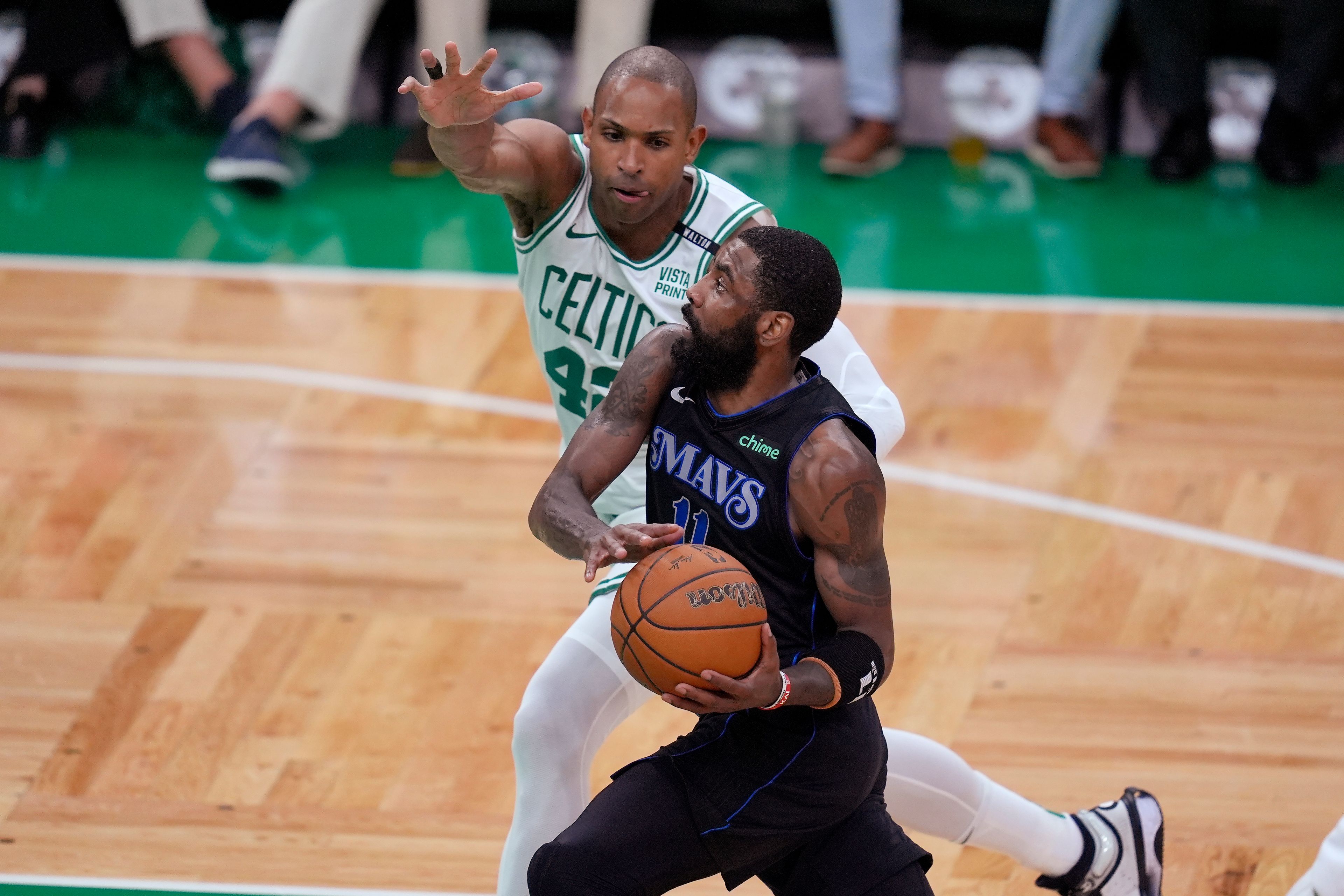 Dallas Mavericks guard Kyrie Irving drives toward the basket as Boston Celtics center Al Horford (42) defends during the first half of Game 1 of basketball's NBA Finals on Thursday, June 6, 2024, in Boston.