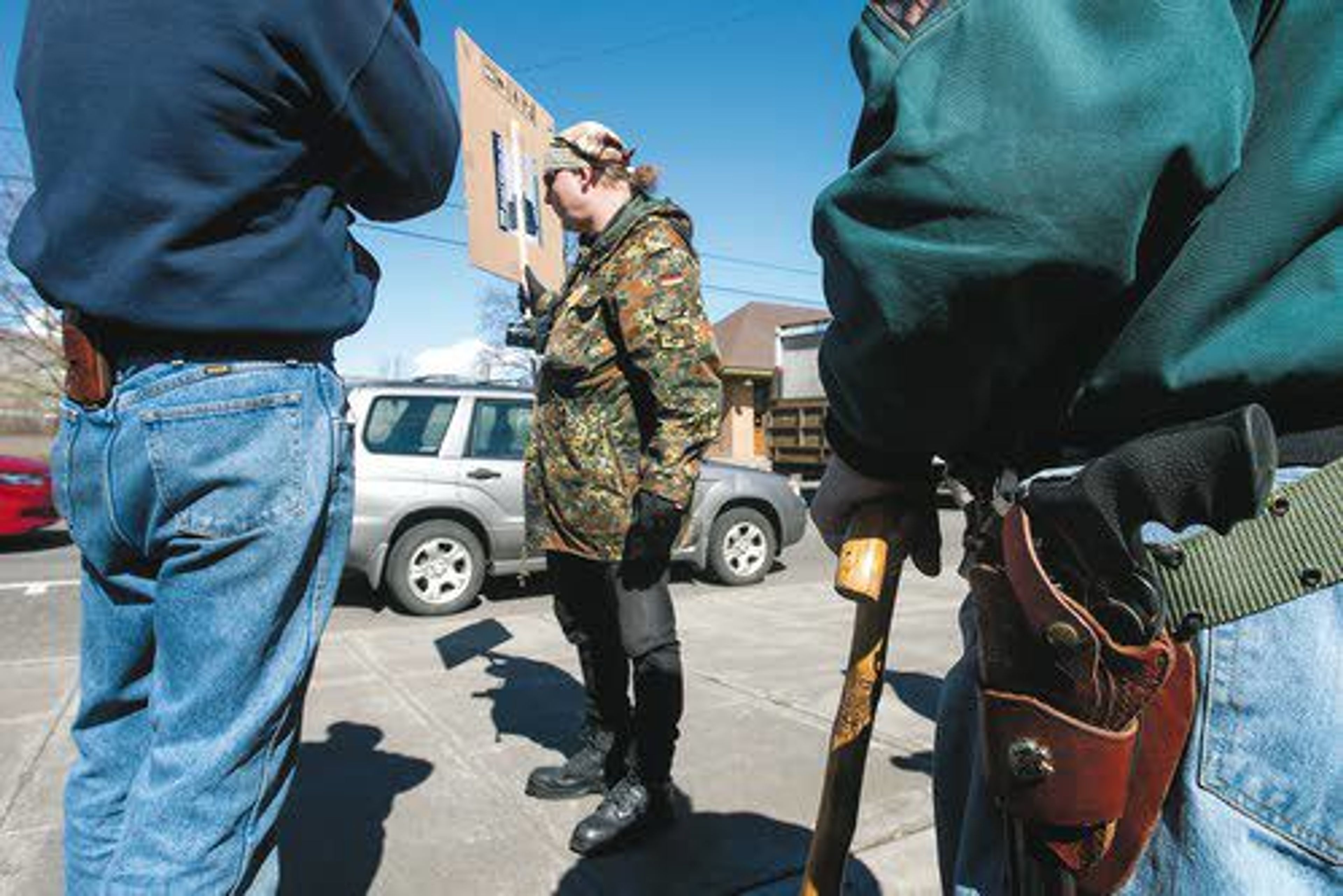 Mike Dietz, center, holds a sign outside the Nez Perce County Courthouse during a pro second amendment rally on Saturday afternoon in Lewiston.