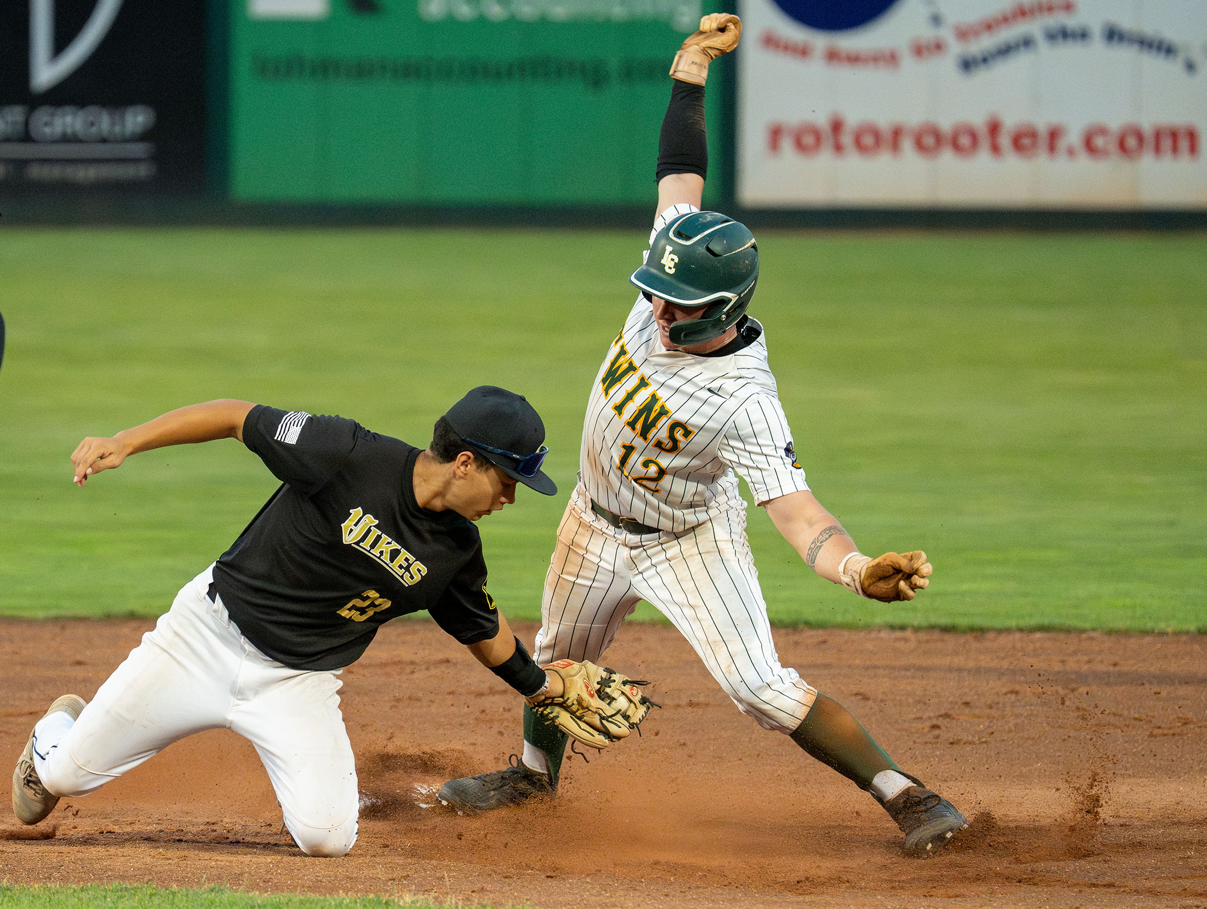 Middleton’s Ethan Romero (23) attempts to tag out the Twins’ Tucker Green (12) as he slides into third base during the game between the Lewis-Clark Twins and the Middleton Vikes in the Idaho AA American Legion State Tournament on Friday at Harris Field in Lewiston. Lewis-Clark defeated Middleton 9-4. 
On Saturday, Lewis-Clark defeated the Twin Falls Cowboys 10-6. 