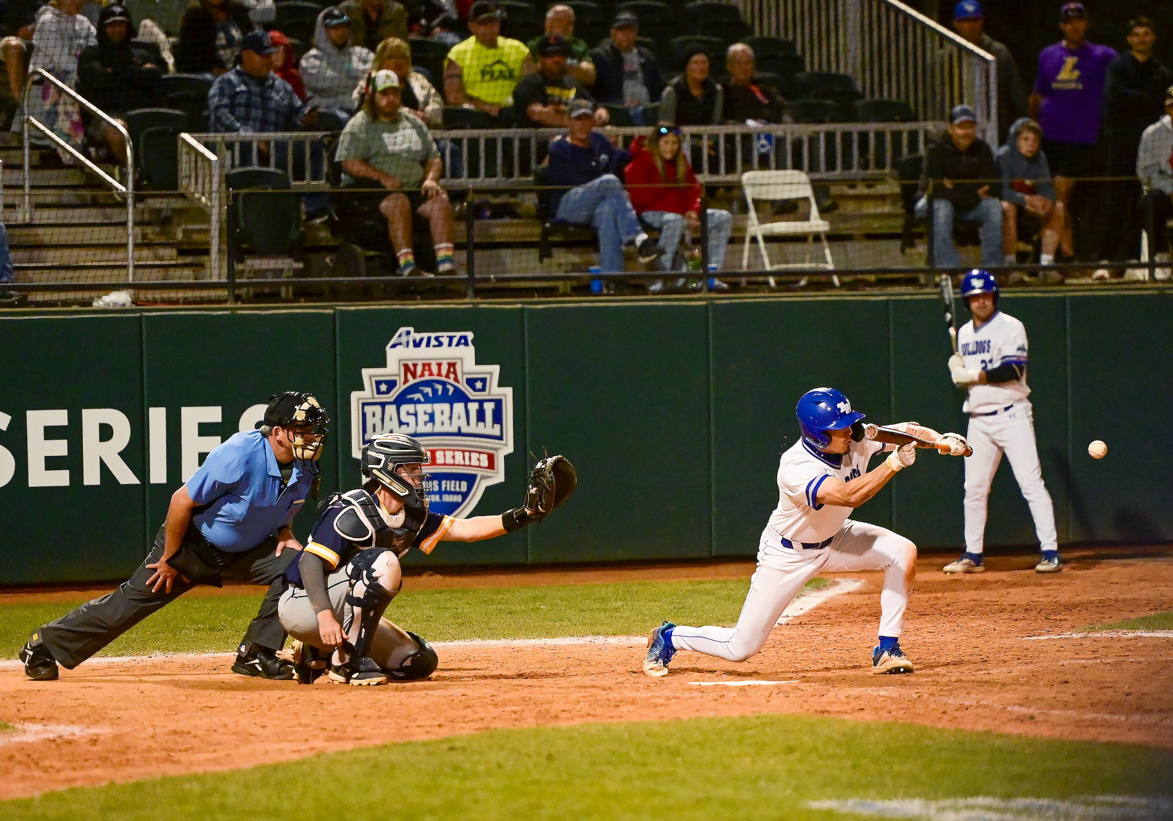 Tennessee Wesleyan’s Braxton Turner bunts the ball in extra innings of Game 18 of the NAIA World Series against Reinhardt at Harris Field in Lewiston on Thursday.