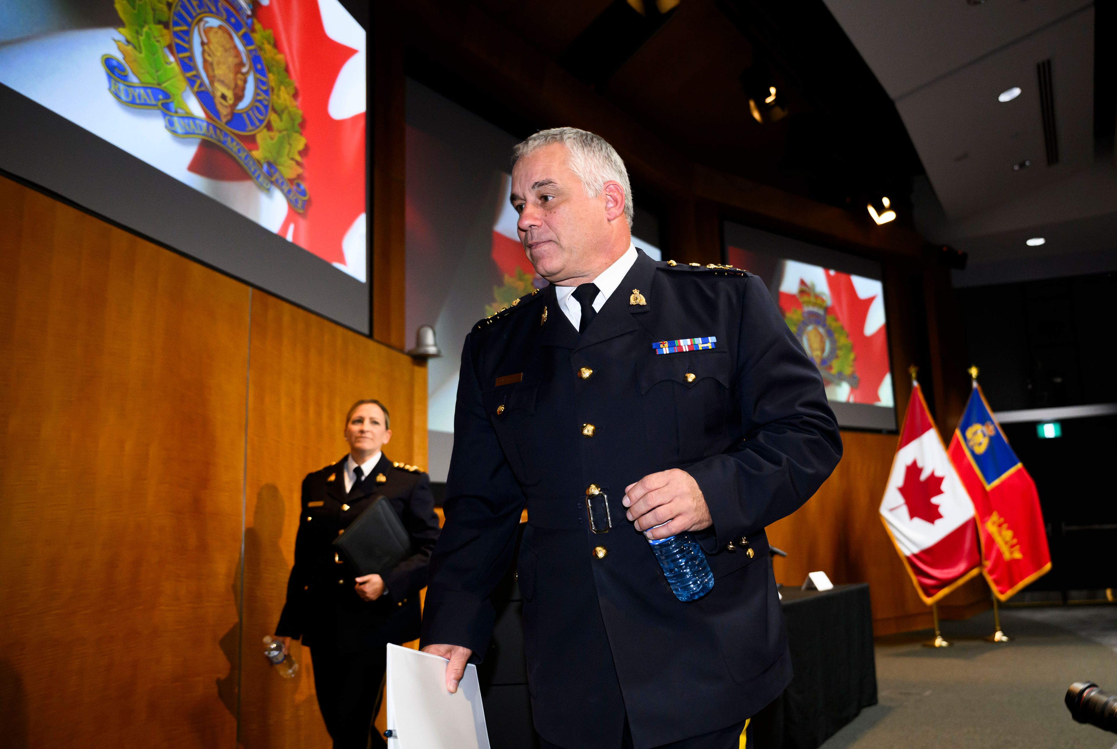 RCMP Commissioner Mike Duheme, centre, and Assistant Commissioner Brigitte Gauvin leave after speaking at a news conference at RCMP National Headquarters in Ottawa, Ontaio, Monday, Oct. 14, 2024. (Justin Tang/The Canadian Press via AP)