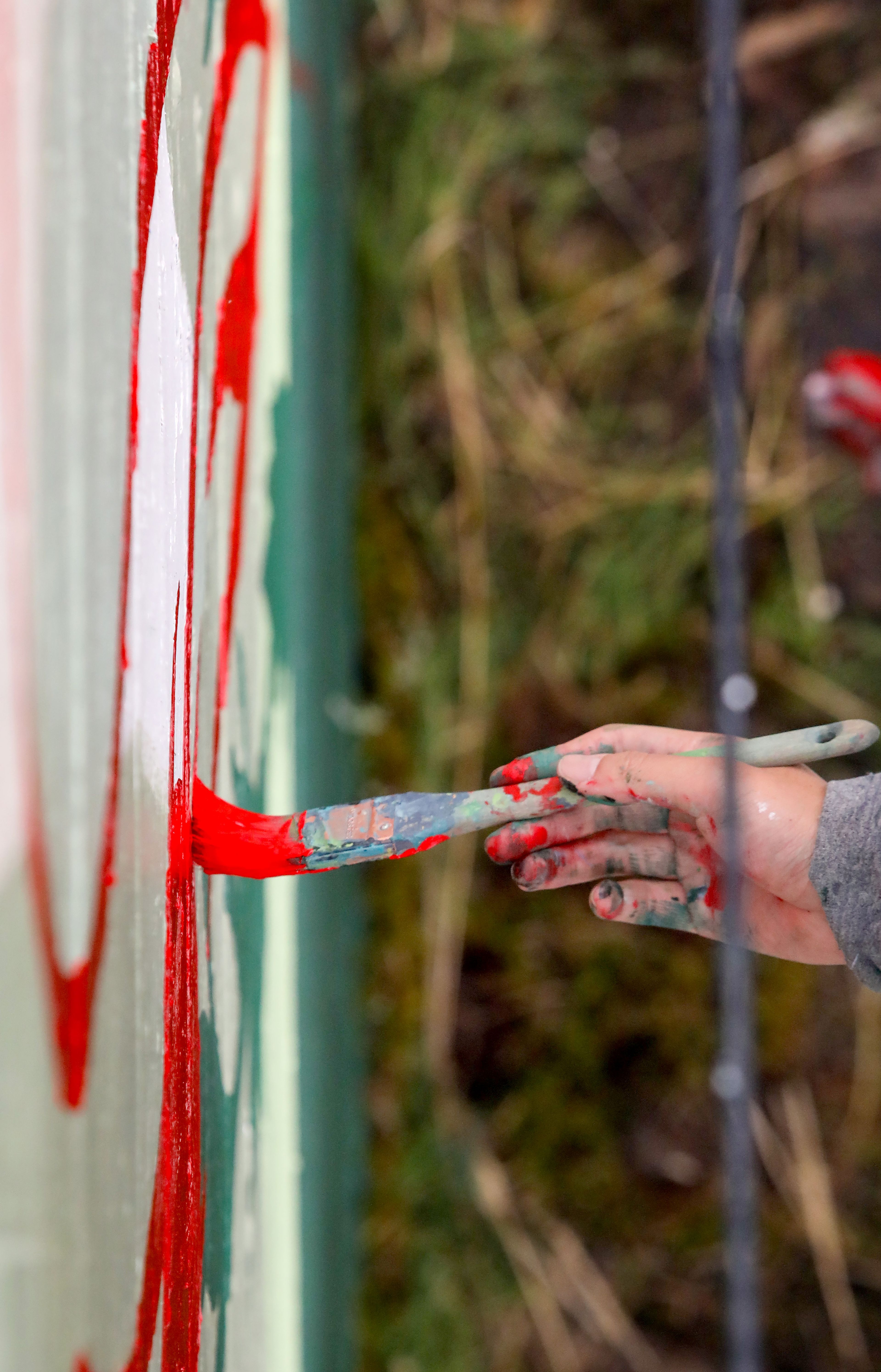 Tori Shao, an artist and landscape architect, works on a new mural in downtown Pullman.