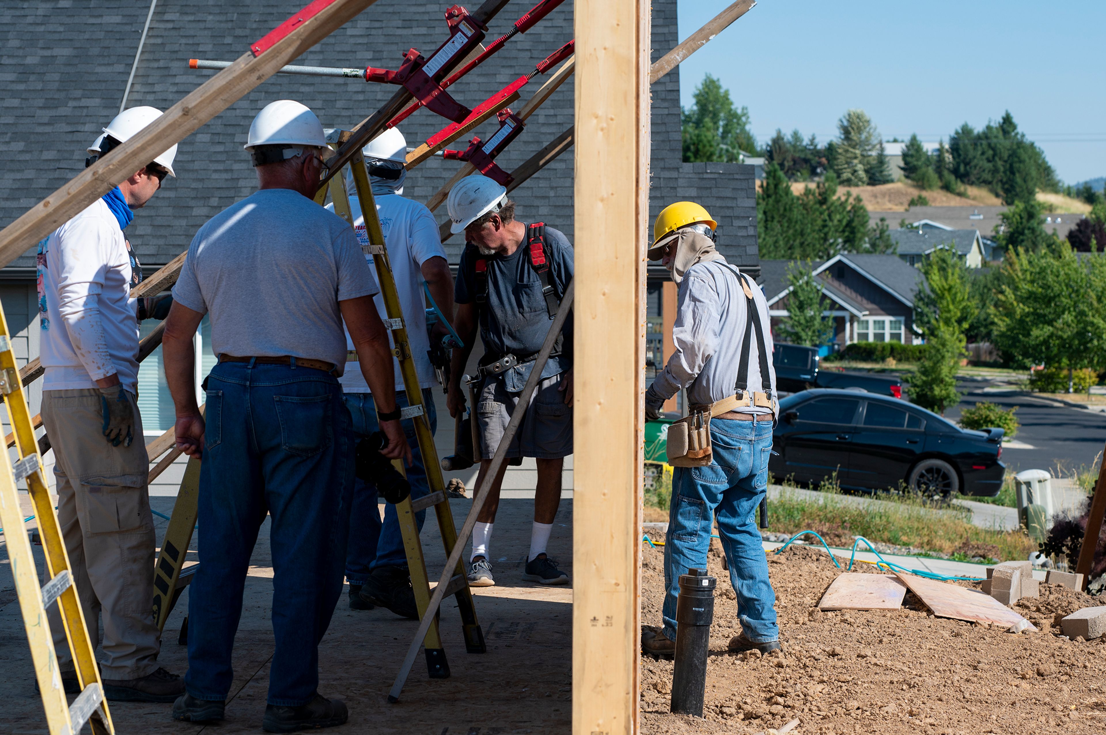 Volunteers from Palouse Habitat for Humanity raise a wall for a home being constructed on Leepike Court in Moscow.